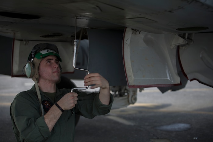 Cpl. Alex Messina, an aircraft mechanic with Marine All-Weather Fighter Attack Squadron 224, tightens a bolt on an F/A-18D Hornet during a pre-flight check while participating in Exercise Harbion Tempest 2014 aboard Clark Air Base, Republic of the Philippines Feb. 20. HT 14 is a small-scale bilateral exercise between the United Sates Marine Corps and the Philippine Air Force training in close-air support, section engaged maneuvering training and combined combat capabilities.