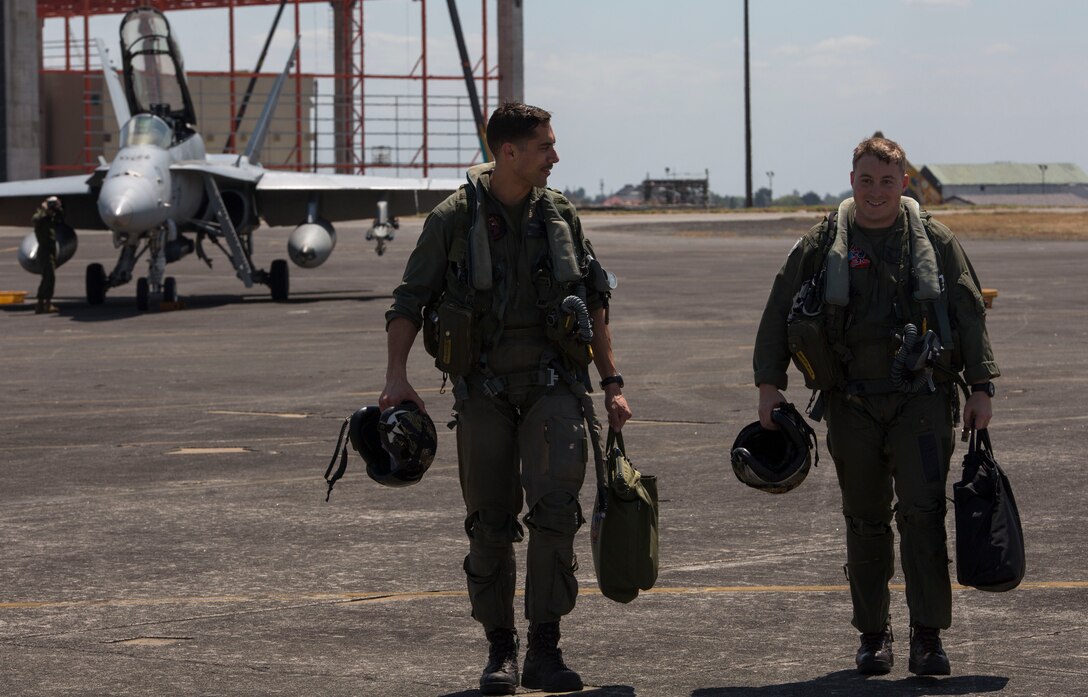 Maj. Norman Mitchell, left, a pilot, and Capt. William Barrett, right, a weapon systems officer with Marine All-Weather Fighter Attack Squadron 224, walk back to their hangar after a successful flight during Exercise Haribon Tempest 2014 aboard Clark Air Base, Republic of the Philippines, Feb. 20. HT 14 is a small-scale bilateral exercise between the United States Marine Corps and the Philippine Air Force. The exercise provides training in close-air support, section engaged maneuvering training and combined combat capabilities.