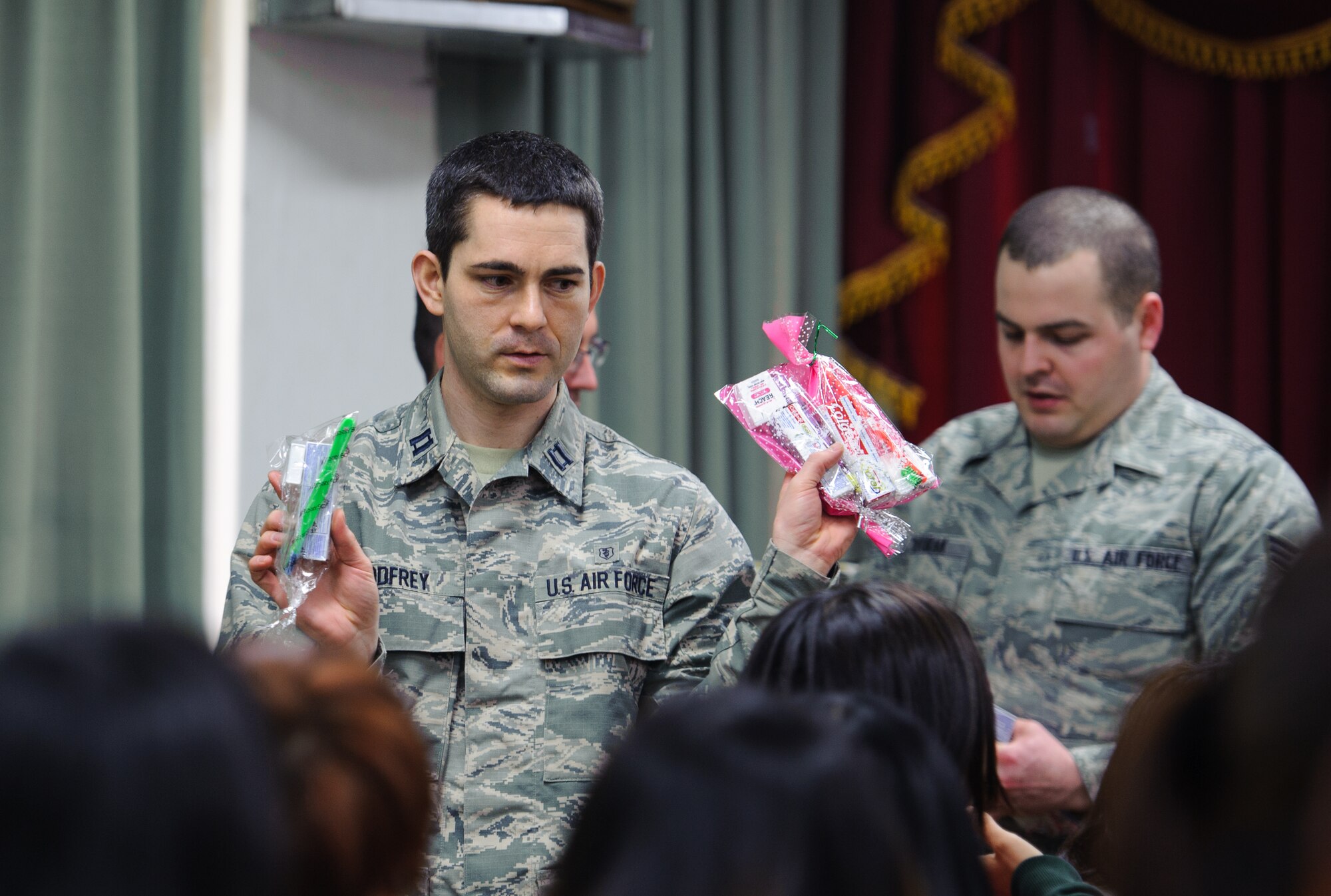 Capt. Thomas Godfrey, 8th Medical Operations Squadron dentist, asks for a child’s preference of toothbrush at Ilmaekwon Orphanage in Gunsan, Republic of Korea, Feb. 27, 2014. The dental clinic visited the orphanage to teach kids proper oral hygiene knowledge and skills as part of the 2014 National Children’s Dental Health Month. (U.S. Air Force photo by Senior Airman Armando A. Schwier-Morales/Released)