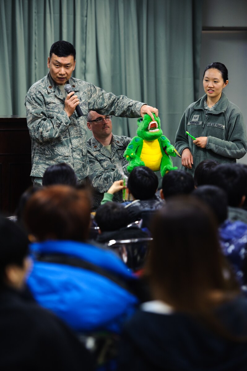 Maj. Jae Lee, 8th Medical Operations Squadron dental services chief, left, and Staff Sgt. Min Hubbard, 8th MDOS dental technician, explain proper brushing techniques at Ilmaekwon Orphanage in Gunsan, Republic of Korea, Feb. 27, 2014. The dental clinic visited the orphanage to teach kids proper oral hygiene knowledge and skills as part of the 2014 National Children’s Dental Health Month. (U.S. Air Force photo by Senior Airman Armando A. Schwier-Morales/Released)