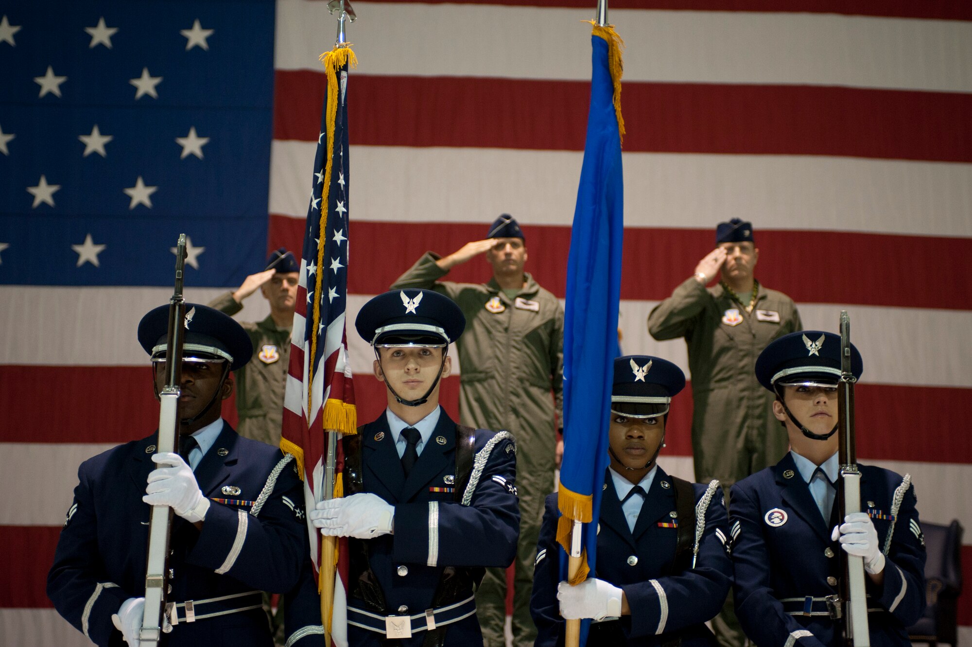 The Nellis Air Force Base Honor Guard presents the colors during the 57th Wing change of command ceremony Feb. 28, 2014 at Nellis AFB Nev.  Col. Christopher Short, 57th WG’s incoming commander, accepted command of the 57th WG during a ceremony in the Thunderbird hanger. (U.S. Air Force photo by Airman 1st Class Timothy Young)