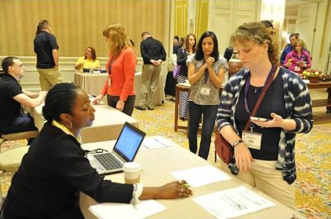 Michelle Lutz (r), wife of Air Force Reserve Chief Master Sgt. Rich Lutz, visits the resource center Feb. 23, 2014, during a Yellow Ribbon Reintegration Program event in Carlsbad, Calif., to find a referral source for counseling in her home state of Washington. The Lutz
family is working through the loss of Michelle's younger brother, who committed suicide the day her husband left for a six-month deployment from the 728th Airlift Squadron at Joint Base Lewis-McChord. (U.S. Air Force photo/Staff Sgt. Jacquelyn Estrada)
