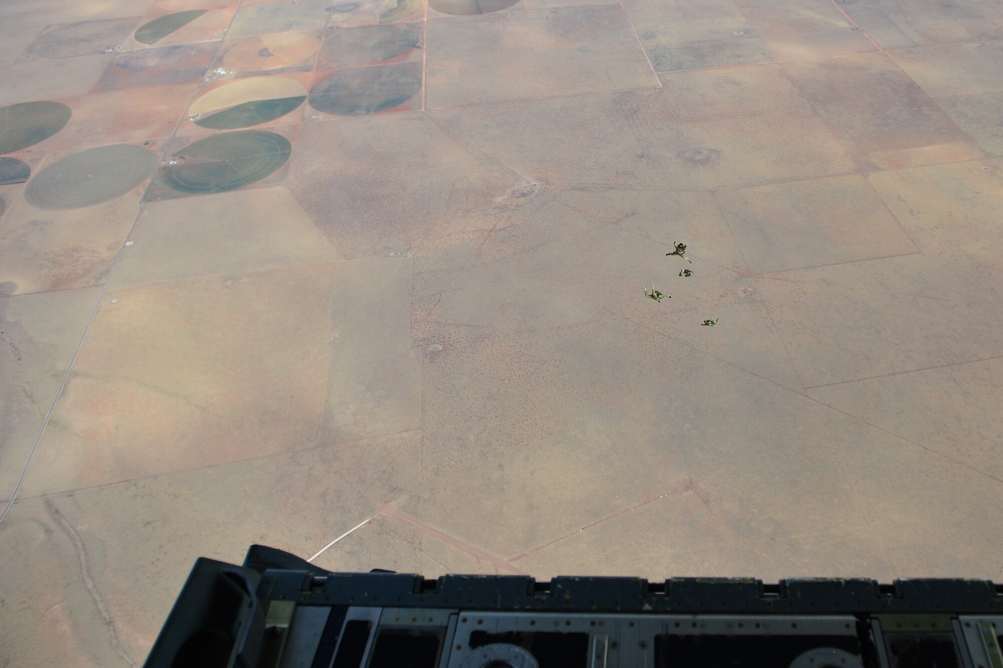 Members from the 26th Special Tactics Squadron free fall from an MC-130J Commando II during a Military Free Fall jump Feb. 28, 2014 at Melrose Air Force Range, N.M. Two members of the 26th Special Tactics Squadron, joined by two other special tactics members, conducted the first Military Free Fall jump in conjunction with one of the many aerial assets maintained at Cannon. (U.S. Air Force photo/ Senior Airman Eboni Reece)