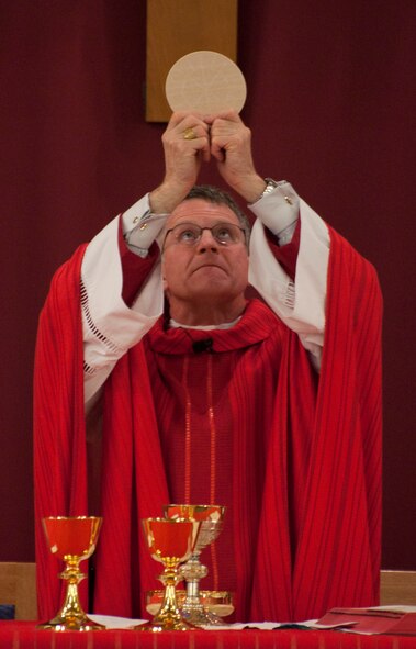 Archbishop Timothy Broglio, Archbishop of the Military Services, raises the communion bread to bless it Feb. 19 during a special confirmation ceremony in the High Plains Church of F.E. Warren Air Force Base, Wyo. The blessing of the bread is a symbolic tradition to signify the Body of Christ. (U.S. Air Force photo by Airman 1st Class Brandon Valle)