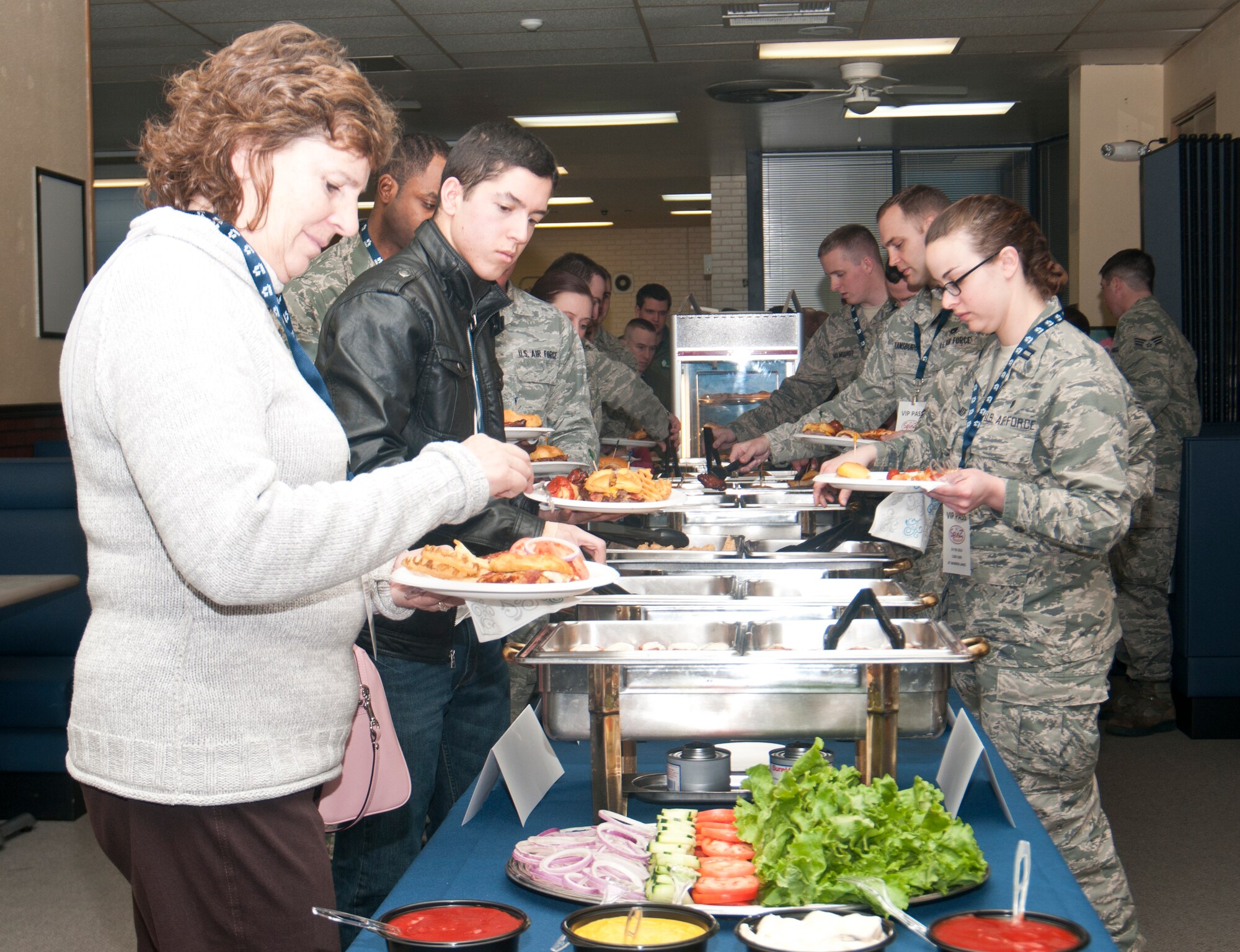 Guests in attendance of the opening of Spinz Hand Crafted Food in Warren Lanes Feb. 24, 2014, sample items from the newly expanded menu. (U.S. Air Force photo by Airman 1st Class Jason Wiese)