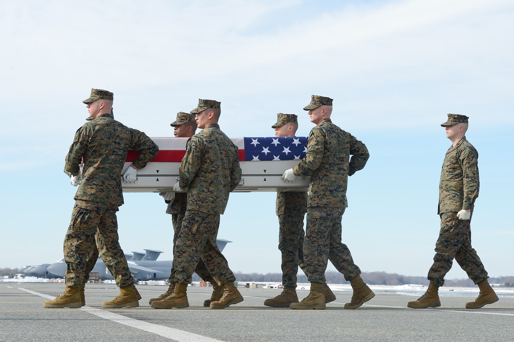 A U.S. Marine Corps carry team transfers the remains of Lance Cpl. Caleb L. Erickson, of Weseca, Minn., March 4, 2014, Dover Air Force Base, Del. Erickson was assigned to 1st Battalion, 9th Marine Regiment, 2nd Marine Division, II Marine Expeditionary Force, Camp Lejeune, N.C. (U.S. Air Force photo/Greg L. Davis)