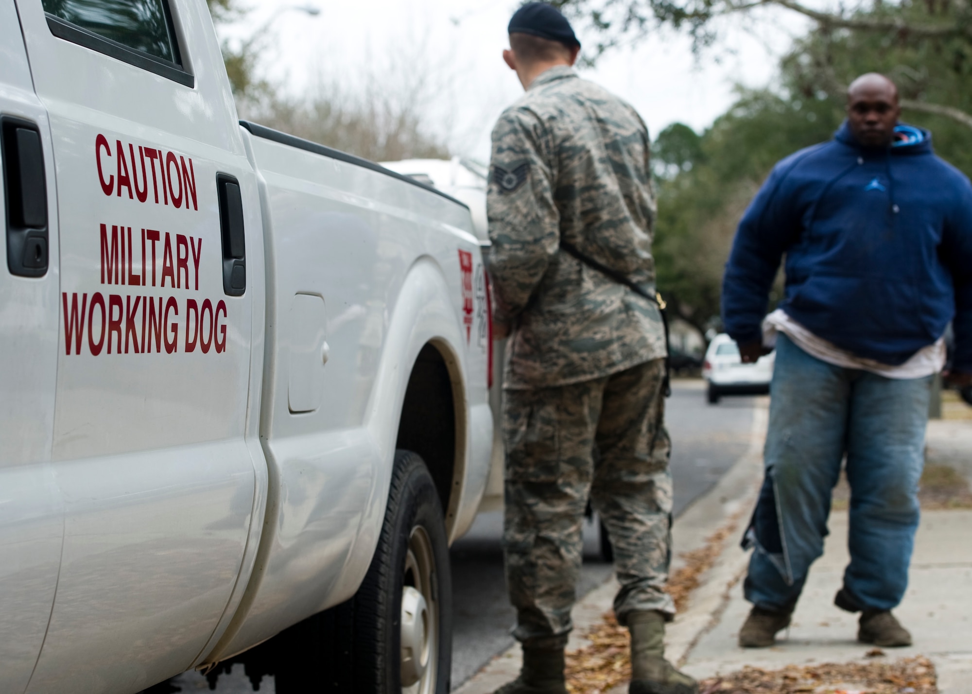 Airmen of the 1st Special Operations Security Forces Squadron prepare for training with a military working dog outside of base housing on Hurlburt Field, Fla., March 3, 2014. MWD handlers worked closely with their dogs to create a trusting relationship to ensure maximum success during real world scenarios. (U.S. Air Force photo/Senior Airman Naomi Griego)  
