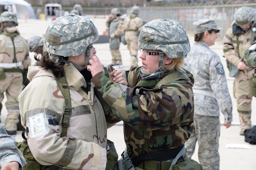 During a Homeland Defense Operational Readiness Exercise at the 144th Fighter Wing March 1, 2014, Technical Sgts. Jennifer Venhaus and Leah Price, both members of the 144th Logistics Readiness Squadron, perform buddy checks while donning individual protection equipment. The exercise is the first for the wing implementing the new Air Force Inspection System and involved several scenarios testing the installation’s ability to survive and operate during incidents and attacks at home station. (Air National Guard photo by Senior Master Sgt. Chris Drudge)