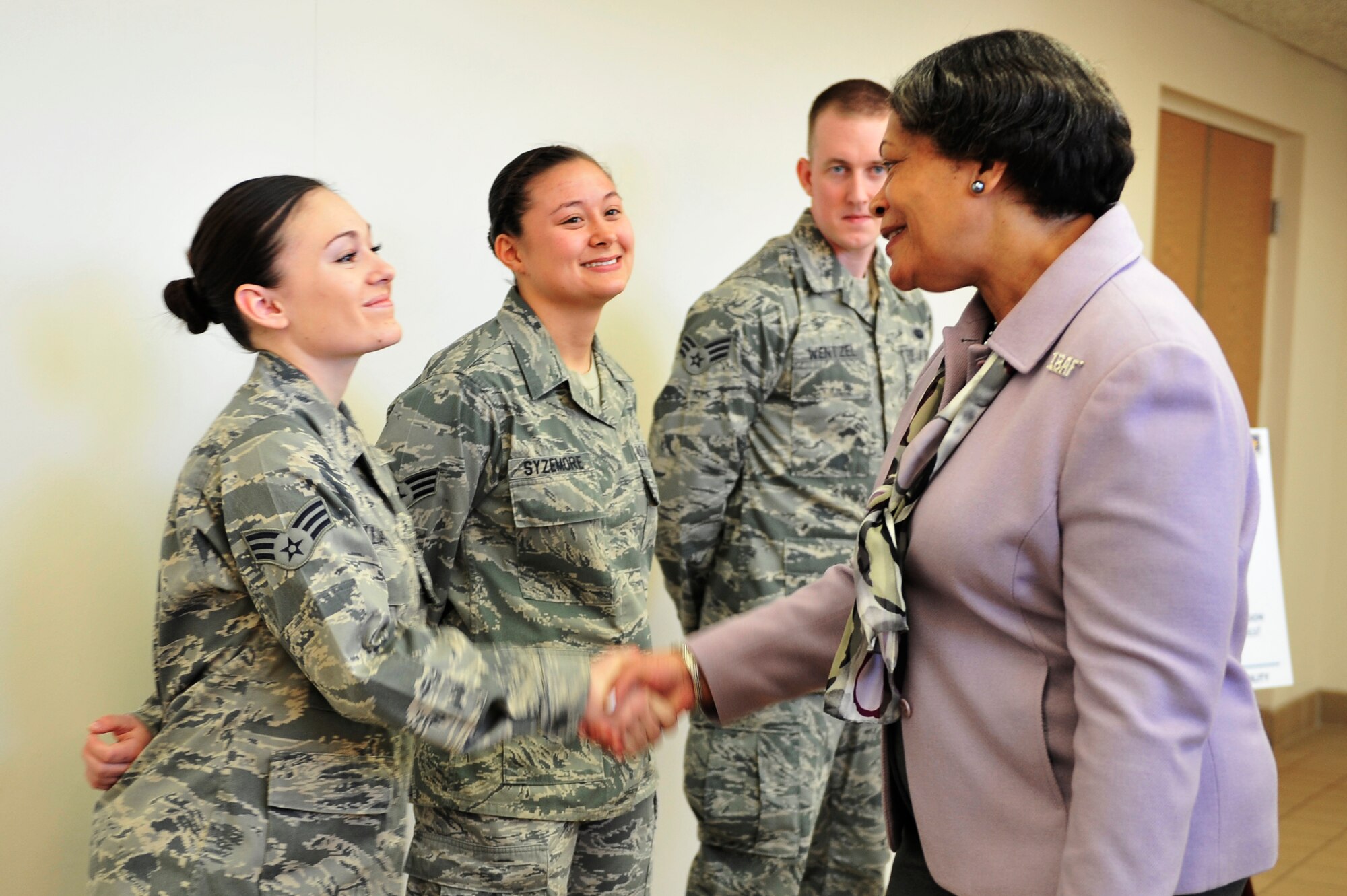 Senior Airman Mariah Williams, 375th Air Mobility Wing broadcast journalist, greets Evelyn McDew during an official visit here Feb. 28, 2014 at Scott Air Force Base, Ill. McDew and her husband, Lt. Gen. Darren W. McDew, 18th Air Force commander, visited a number of wing organizations including the chapel, the 375th Medical Group and the Sexual Assault Response Coordinator. At each location, they were briefed on how the organization contributes to the overall wing mission. (U.S. Air Force photo/Airman 1st Class Kiana Brothers)