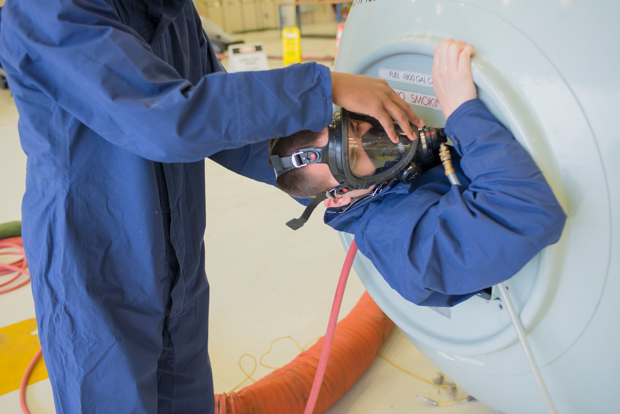 U.S. Air Force Senior Airman Theodore Ross, 23d Component Maintenance Squadron fuel systems maintenance journeyman, enters a confined space trainer during an exercise at Moody Air Force Base, Ga., Mar. 4, 2014. If the Airmen initially responding cannot extract the casualty, responders will call the fire department to assist. (U.S. Air Force photo by Airman 1st Class Ryan Callaghan/Released)
