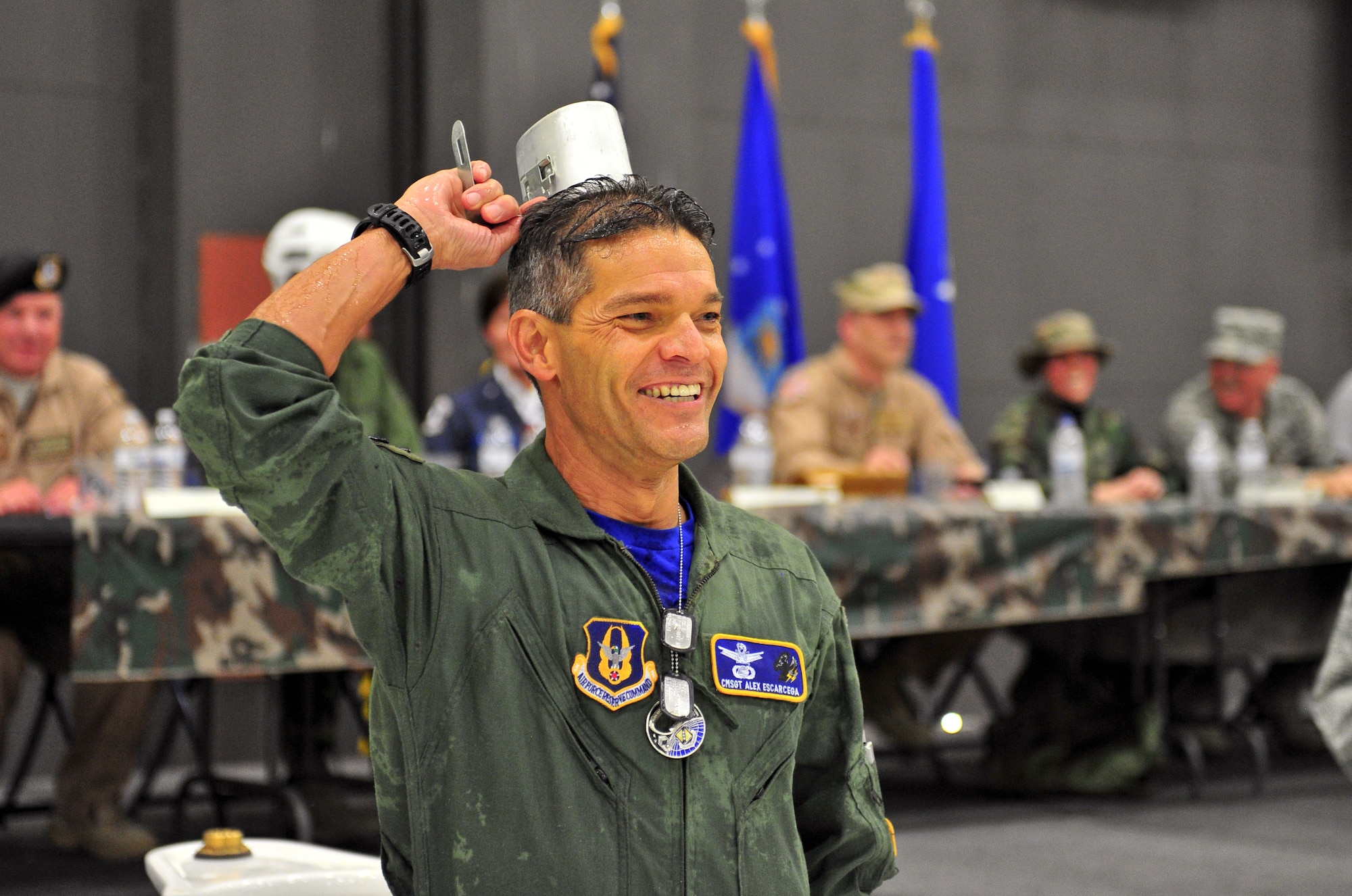 Air Force Reserve Chief Master Sgt. Alex Escarcega proves to the crowd he polished off his drink after having to sip from 310th Space Wing's "grog bowl" March 1, 2014, during the wing's Combat Dining In/Annual Awards Ceremony at Peterson Air Force Base, Colo. The wing sponsored the event to both recognize its annual award winners and bring together the Reservists for an evening of esprit de corps, unit morale and camaraderie. Escarcega is the 310th Operations Group chief enlisted manager. (U.S. Air Force photo/Tech. Sgt. Nicholas B. Ontiveros)