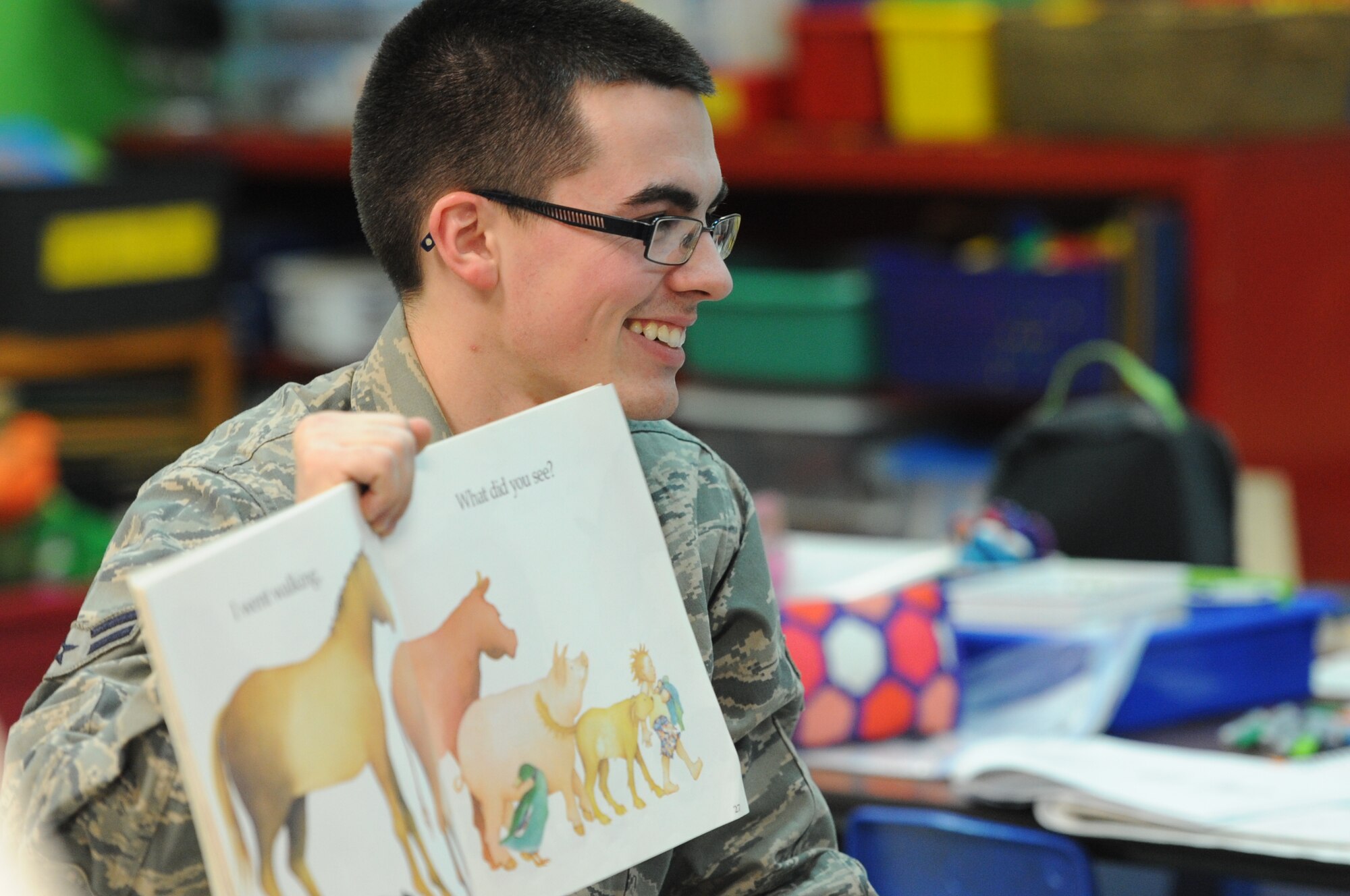 ALTUS AIR FORCE BASE, Okla. – U.S. Air Force Airman 1st Class John Kavanagh, 97th Contracting Squadron contract specialist, reads to a kindergarten class as part of the Read Across America program at L. Mendel Rivers Elementary School March 3, 2014. Read Across America is a nationwide program that helps children develop a love for reading by making it fun. Altus AFB Airmen traveled to three different elementary schools to read to students from surrounding communities. (U.S. Air Force photo by Senior Airman Levin Boland/Released) 