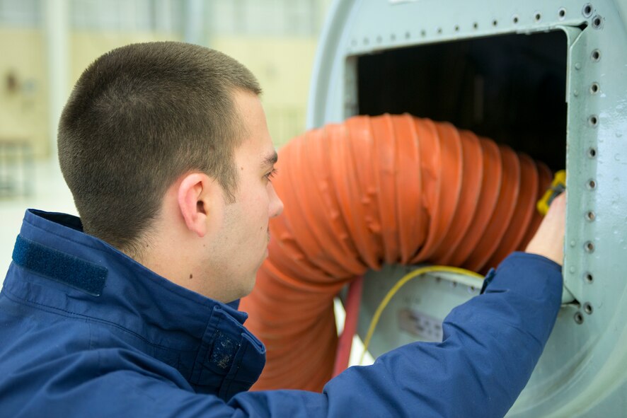 U.S. Air Force Senior Airman Theodore Ross, 23d Component Maintenance Squadron fuel systems maintenance journeyman, checks environmental conditions within a C-130 fuselage tank using a photo ionization detector at Moody Air Force Base, Ga., Mar. 4, 2014. Ross participated in a confined space casualty extraction exercise, meant to simulate rescuing an unconscious or incapacitated Airman from a fuselage tank. (U.S. Air Force photo by Airman 1st Class Ryan Callaghan/Released)

