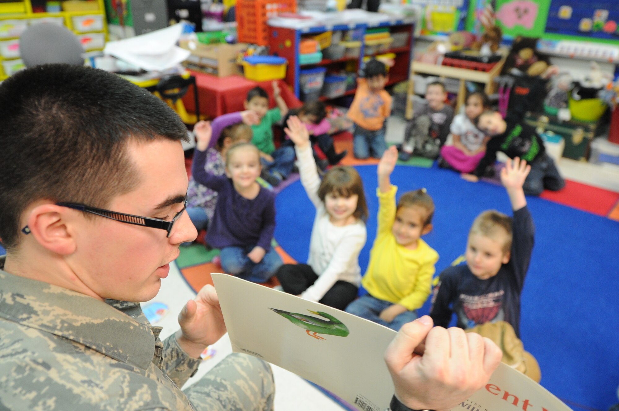 ALTUS AIR FORCE BASE, Okla. – U.S. Air Force Airman 1st Class John Kavanagh, 97th Contracting Squadron contract specialist, quizzes a kindergarten class about different kinds of animals as part of the Read Across America program at L. Mendel Rivers Elementary School March 3, 2014. Read Across America is a nationwide program that helps children develop a love for reading by making it fun. (U.S. Air Force photo by Senior Airman Levin Boland/Released) 