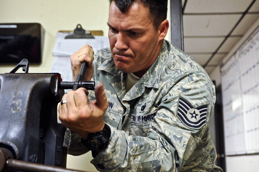 Tech. Sgt. Johnny Ellison, 1st Special Operations Security Forces Squadron combat arms NCO in charge, secures a vice to hold a M-4 rifle barrel at the combat arms section on Hurlburt Field, Fla., March 3, 2014. Ellison replaced the rifle's barrel after the previous old became damaged. (U.S. Air Force photo/Senior Airman Michelle Patten)