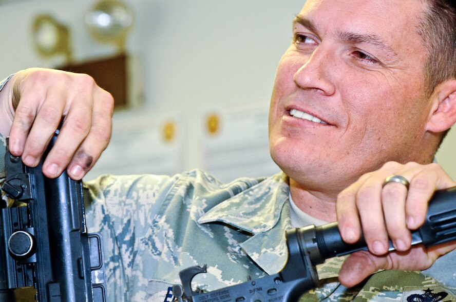 Tech. Sgt. Johnny Ellison, 1st Special Operations Security Forces Squadron combat arms NCO in charge, disassembles a M-4 rifle at the combat arms section on Hurlburt Field, Fla., March 3, 2014. Combat Arms Airmen inspected weapons to verify they’re safe to fire. (U.S. Air Force photo/Senior Airman Michelle Patten)