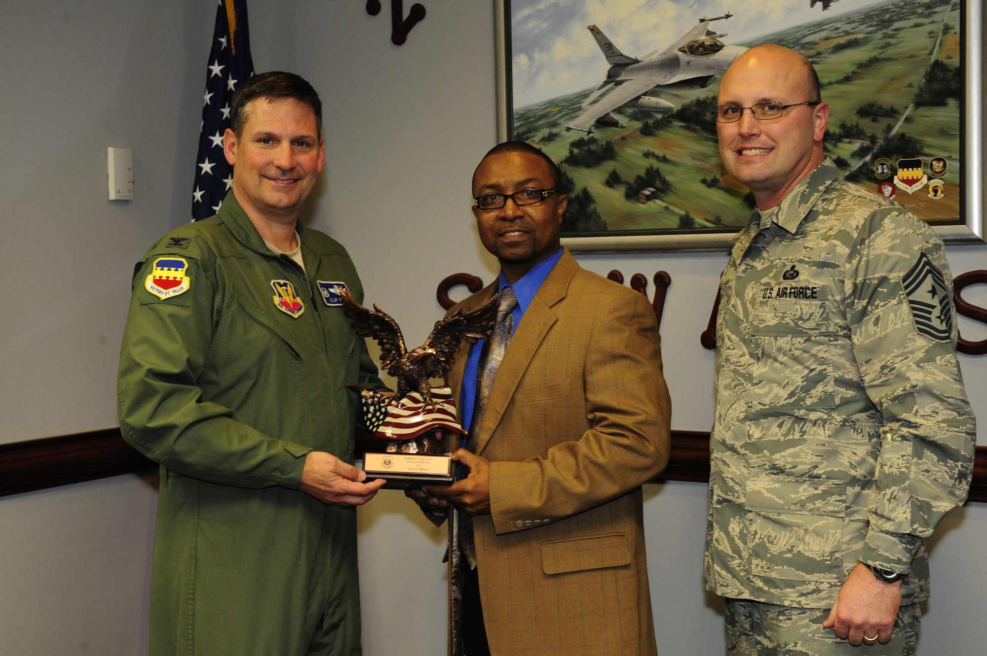 Lew Barron, 20th Mission Support Group computer assistant flight administrator, recieves the GS-6 and below civilian of the year award from Ninth Air Force on Shaw Air Force Base, S.C., March 3, 2014. Annual awards are given to those who show dedication to their job and a passion for self-improvement through volunteering and education. (U.S. Air Force photo by Airman 1st Class Diana M. Cossaboom/Released)