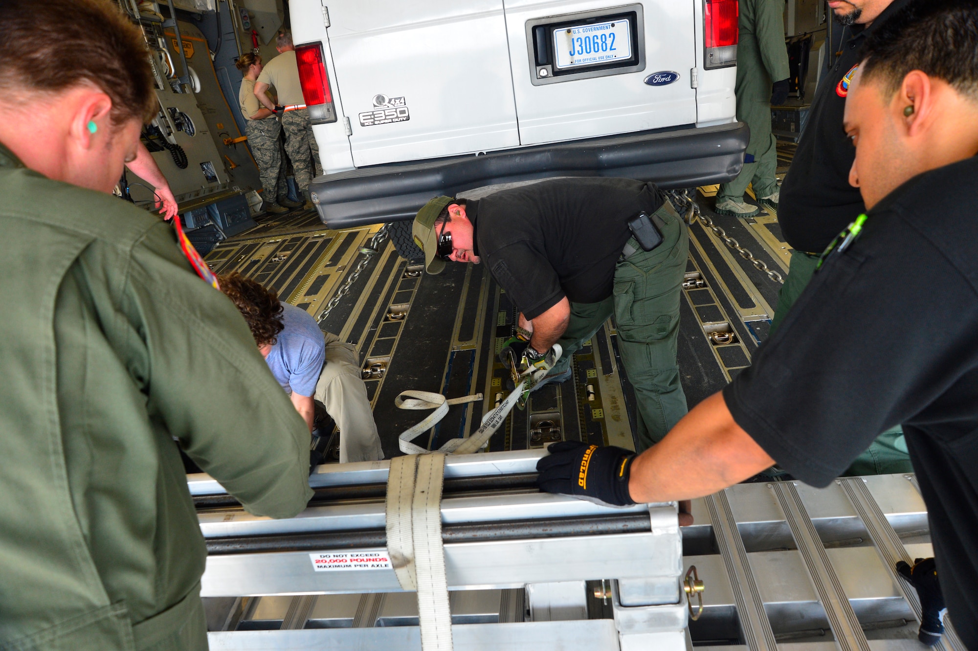 Members of the 326th Airlift Squadron and the Federal Bureau of Investigation Washington Field Office rapid deployment team work together to secure equipment on a C-17 Globemaster III during Operation Patriot Sands, Feb. 21, 2014, at Homestead Air Reserve Base, Fla. Patriot Sands is a joint response exercise that involved 5 reserve units, multiple FBI teams, FEMA and a Florida Advanced Surgical Transport Team. (U.S. Air Force photo/Staff Sgt. Elizabeth Morris)
