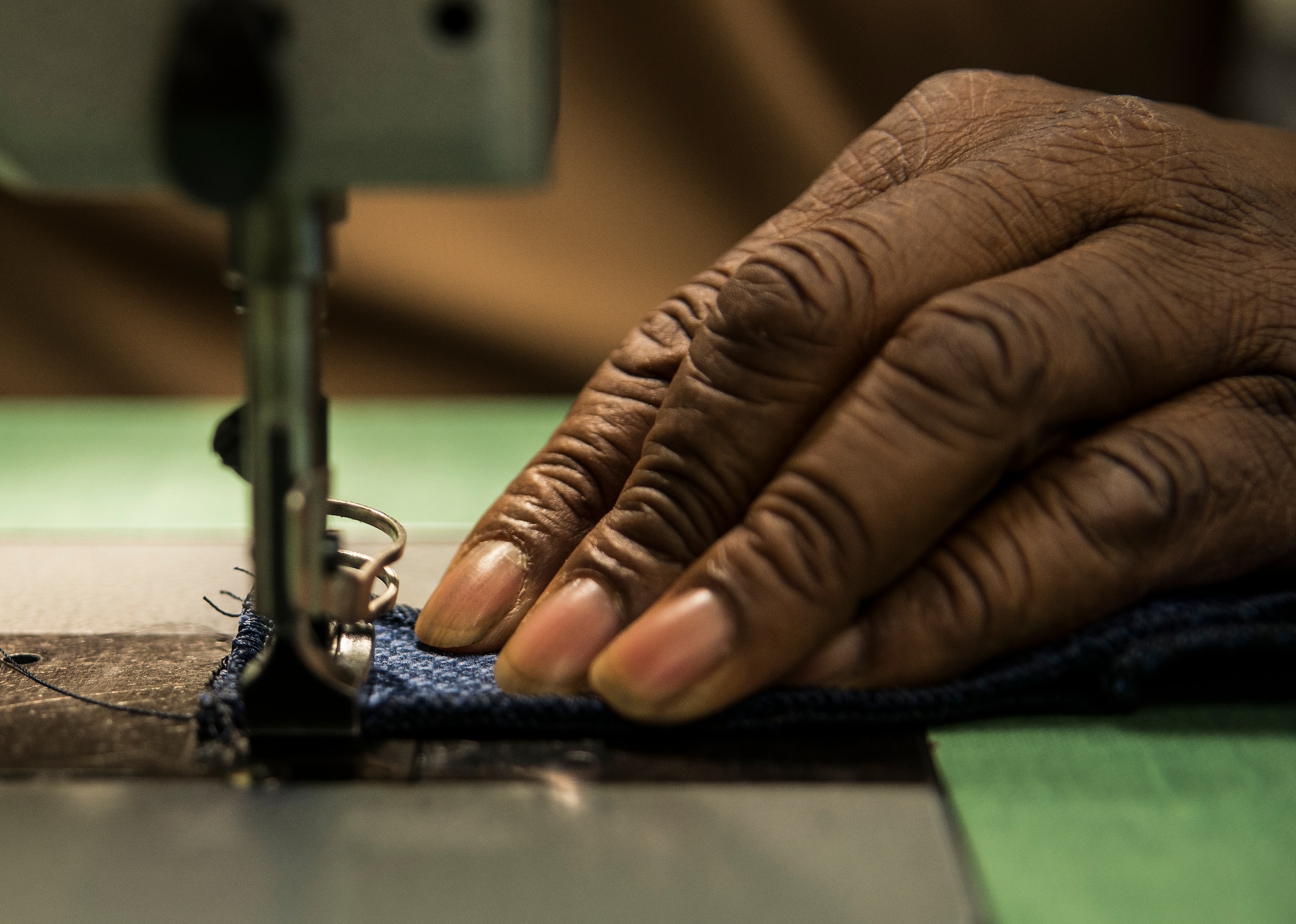 Isreal Middleton, 437th Aircrew Flight Equipment fabrication shop, uses a sewing machine to fabricate a seat cover used on a C-17 Globemaster III Feb. 20, 2014, at Joint Base Charleston – Air Base, S.C. Middleton and nine other civilians work in the fabrication shop which saves the Air Force more than one million dollars every year by fabricating all fabric-related material used on JB Charleston’s C-17s. (U.S. Air Force photo/ Senior Airman Dennis Sloan)