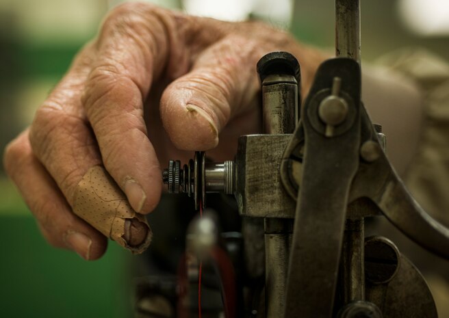 Bobby Pierce, 437th Aircrew Flight Equipment fabrication shop, adjusts a part on a sewing machine Feb. 20, 2014, at Joint Base Charleston – Air Base, S.C. Pierce has worked in the fabrication shop for more than 30 years. (U.S. Air Force photo/ Senior Airman Dennis Sloan)
