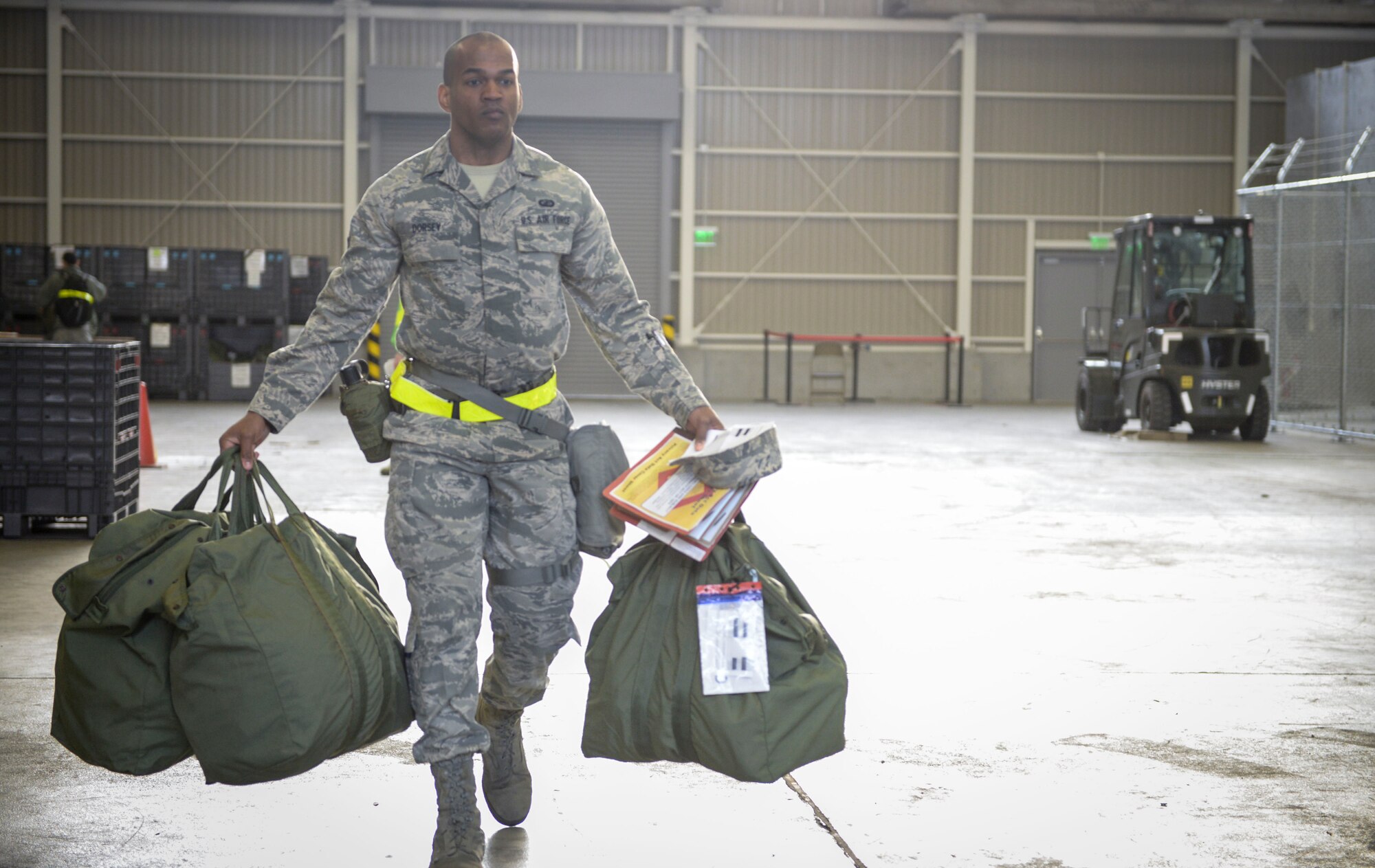 Airman 1st Class Quortez Dorsey, 374th Contracting Squadron is issued Mission Oriented Protective Posture gear during a Samurai Readiness Inspection at Yokota Air Base, Japan, March 4, 2014. 374th  Logistics Readiness Squadron Airmen are responsible for all individual protective equipment used by Yokota Airmen during exercises and real-world contingencies. (U.S. Air Force photo by Airman 1st Class David Danford/released)