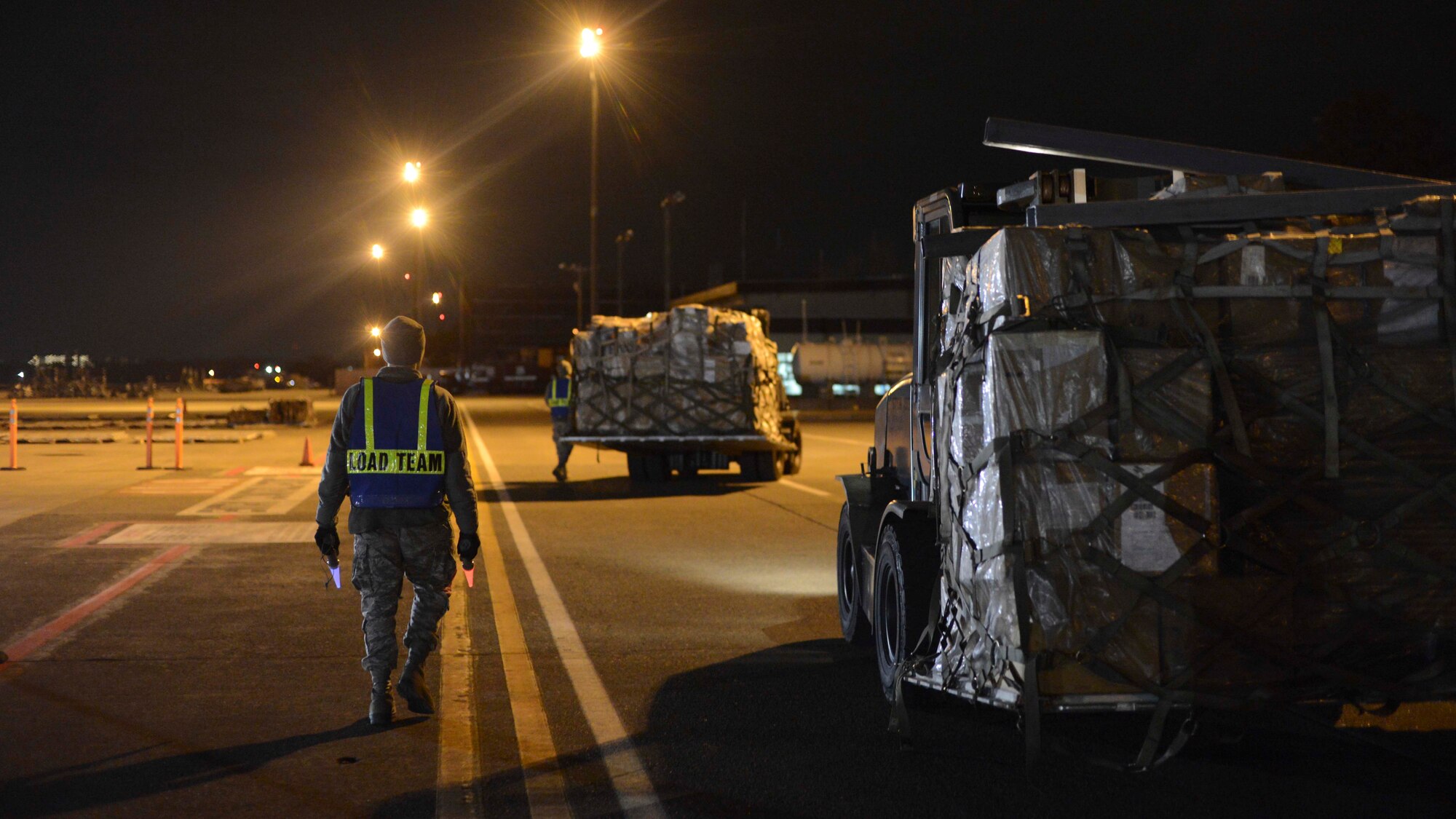 Airman 1st Class Myron Lucan, 374th Maintainer Squadron propulsion journeyman, escorts a forklift during the Samurai Readiness Inspection at Yokota Air Base, Japan, March 4, 2014.  Yokota Airmen faced numerous scenarios to help them improve their skills as a professional airlift hub.  (U.S. Air Force photo by Airman 1st Class Soo C. Kim / released)