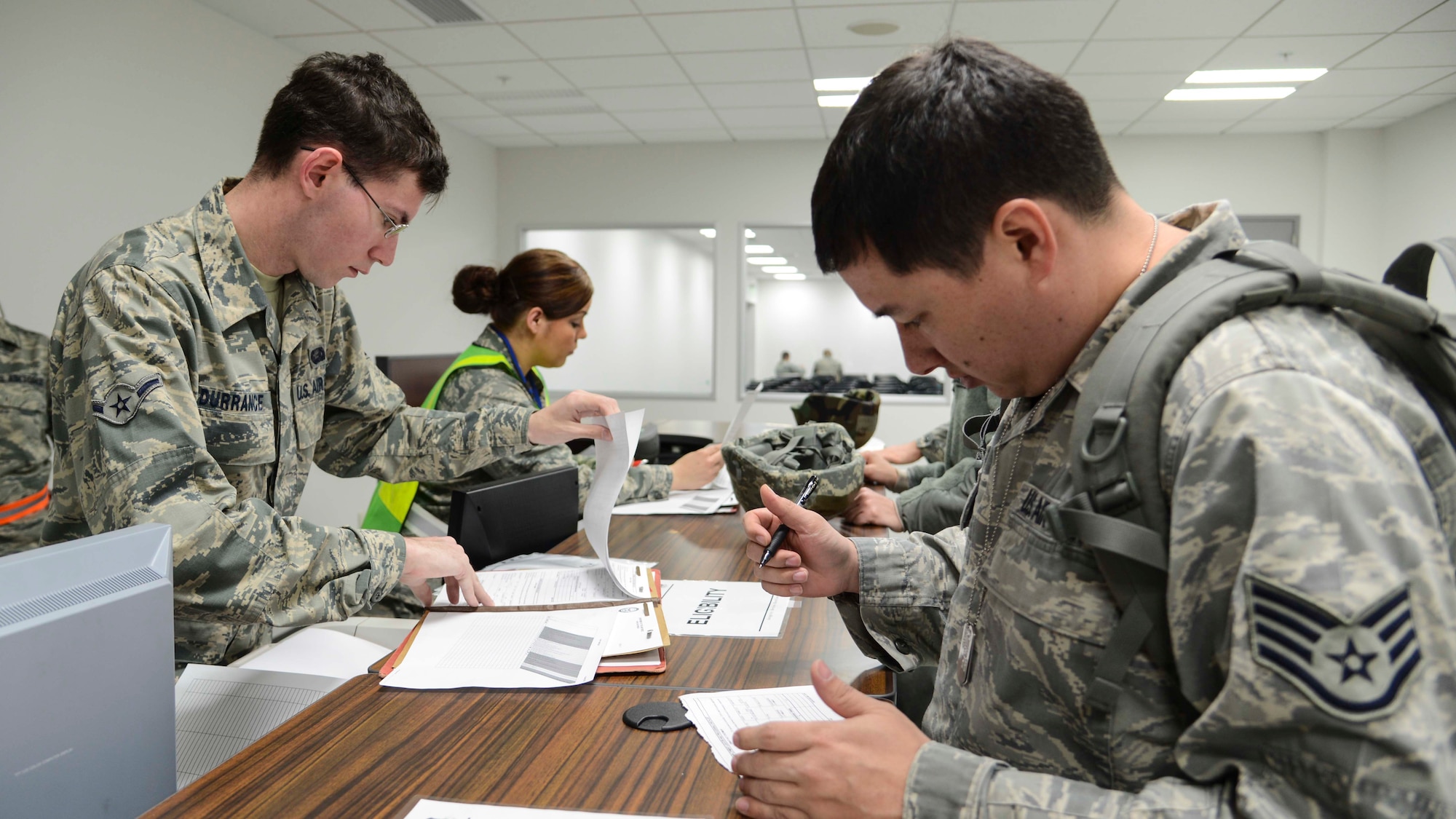 Staff Sgt. Joel Arnett, 374th Operation Support Squadron weather forecaster, processes through a deployment line during the Samurai Readiness Inspection at Yokota Air Base, Japan, March 4, 2014.  The purpose of deployment line is to allow Airmen to receive quick administrative assistance prior to their deployment.  (U.S. Air Force photo by Airman 1st Class Soo C. Kim / released)
