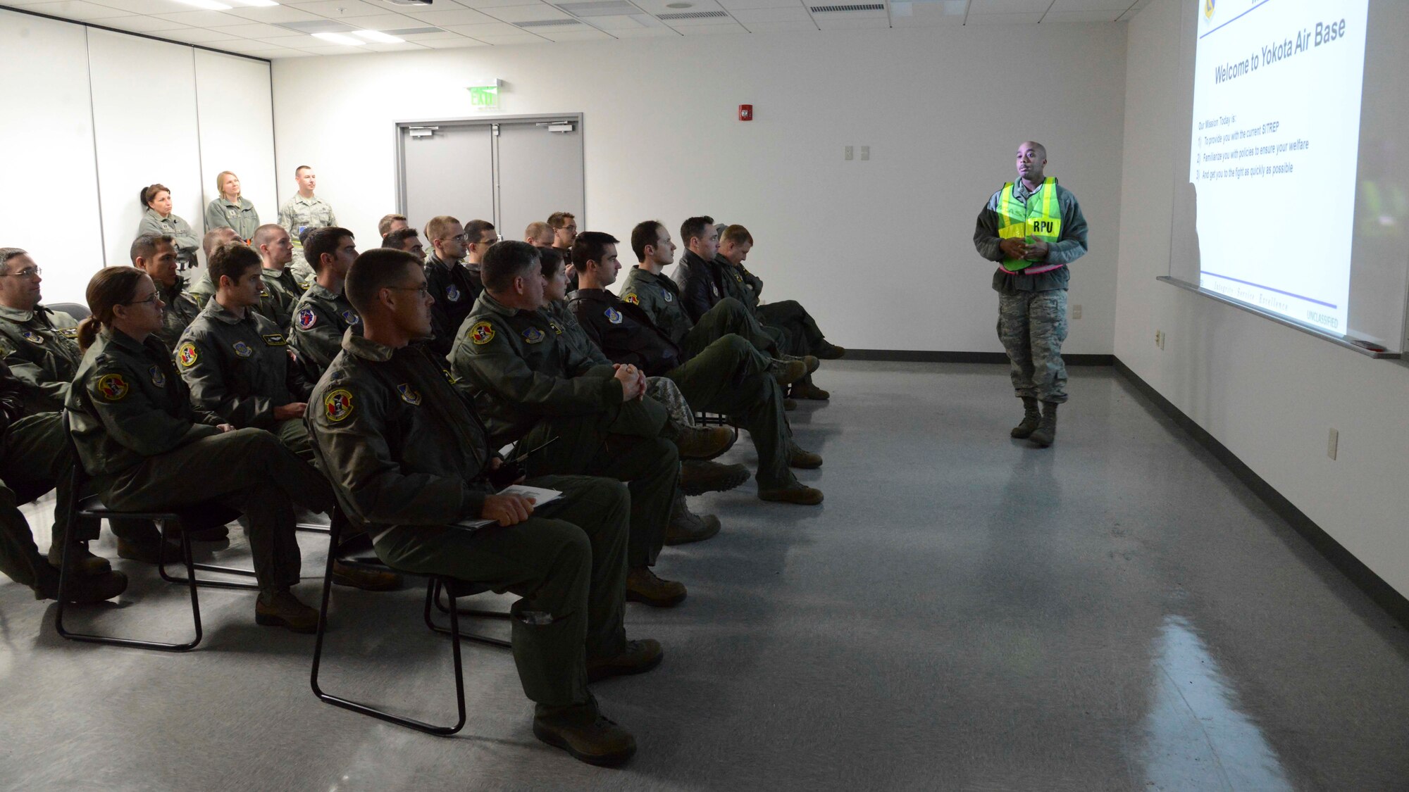 Staff Sgt. Oundra Scott, 374th Force Support Squadron customer support supervisor, gives a briefing to simulated arriving personnel during the Samurai Readiness Inspection at Yokota Air Base, Japan, March 4, 2014. Yokota keeps its Airmen prepared to assist anywhere in the Pacific theater using thorough inspections. (U.S. Air Force photo by Airman 1st Class Soo C. Kim / released)