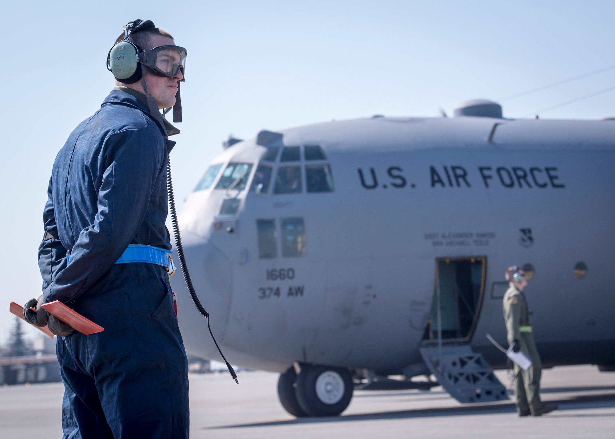 A maintainer from the 374th Aircraft Maintenance Squadron prepares to marshal a C-130 Hercules during a Samurai Readiness Inspection at Yokota Air base, Japan, March 4, 2014. During the inspection, maintainers, aircrew and base support functions must synchronize their efforts to complete a series of simulated deployment tasks in order to demonstrate their ability to respond to real-world crises. (U.S. Air Force photo by Capt. Raymond Geoffroy/Released)