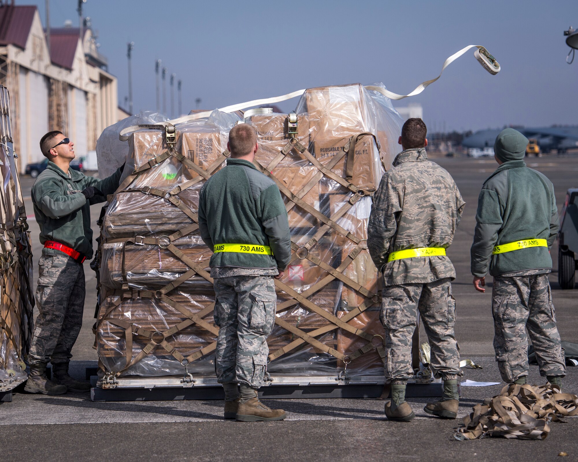 Airmen from the 730th Air Mobility Squadron prepare cargo for deployment during a Samurai Readiness Inspection at Yokota Air base, Japan, March 4, 2014. The inspection was designed to evaluate Yokota’s ability to perform provide airlift capabilities through a variety of contingency response scenarios. (U.S. Air Force photo by Capt. Raymond Geoffroy/Released)