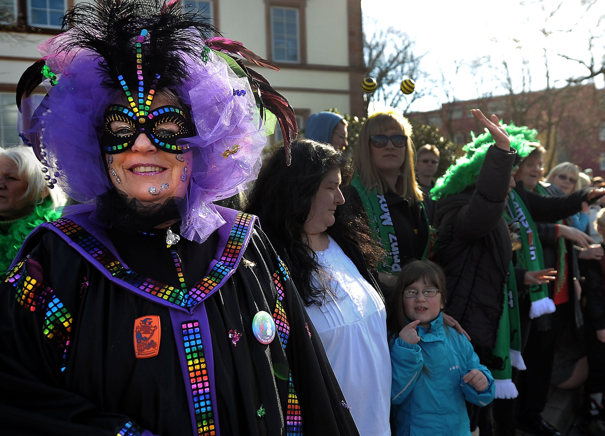 A Carnavale reveler watches the parade pass during Fasching celebrations March 4, 2014, Ramstein Village, Germany. This annual event is a pre-Lenten carnival, which is celebrated with the donning of wild and fancy costumes to chase away the evil spirits of winter in preparation for spring. (U.S. Air Force photo/ Sara Pavich)