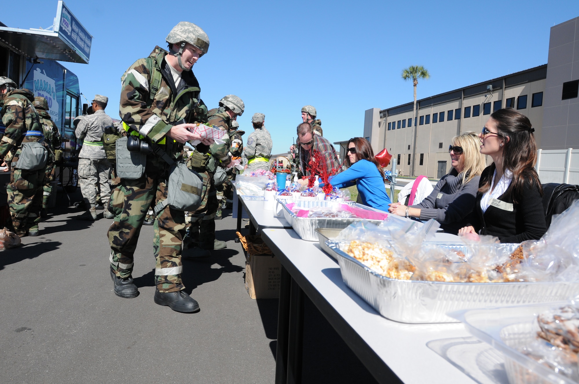 U.S. Air Force Technical Sgt Aron White, Avionics Specialist with the 125th Fighter Wing, Florida Air National Guard takes advantage of great food from local food trucks, and sweet goodies, arranged by the Key Spouse Program during Operation  Eagle Claw a Combat Skills Training Exercise, Jacksonville Fl, February 28, 2014. The ongoing Combat Skills Training ensures the 125th is prepared and ready to defend the State and Nation at all times. (Pictured (U.S. Air National Guard photo by SMSgt Shelley Gill, Released)
