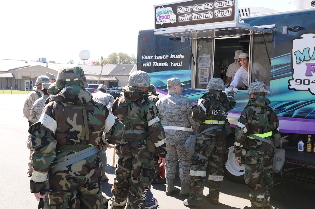 U.S. Air Force Airmen with the 125th Fighter Wing, Florida Air National Guard take advantage of great food from local food trucks, and sweet goodies, arranged by the Key Spouse Program during Operation  Eagle Claw a Combat Skills Training Exercise, Jacksonville Fl, February 28, 2014. The ongoing Combat Skills Training ensures the 125th is prepared and ready to defend the State and Nation at all times. (U.S. Air National Guard photo by SMSgt Shelley Gill, Released)