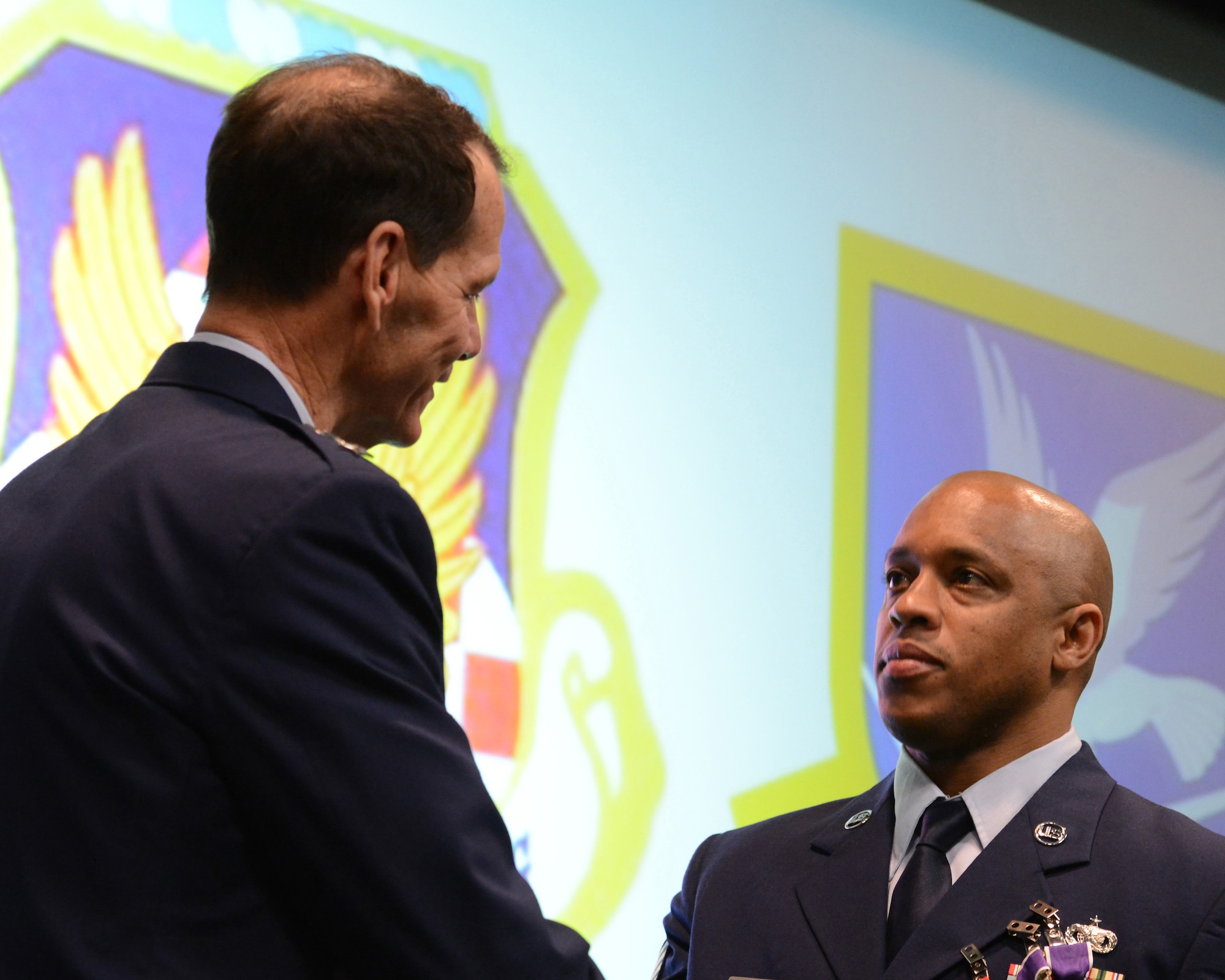 Air Force commends Staff Sgt. Nigel Darby, 105th Base Defense Squadron, New York Air National Guard, receives his second Purple Heart Medal from Lt. Gen. Stanley E. Clark III, the director of the Air National Guard, at an awards ceremony at Stewart Air National Guard Base, N.Y., March 2, 2014. A total of 29 medals were awarded to include 5 Bronze Stars, 12 Purple Hearts, and 12 Air Force Combat Action Ribbons to 20 Air Guardsmen of the 105th Base Defense Squadron deployed with the 820th Base Defense Group, Moody Air Force Base, Ga., to provide “outside the wire” base defense of Bagram Airfield, Parwan province, Afghanistan. (U.S. Air National Guard photo by Tech. Sgt. Michael OHalloran/Released)