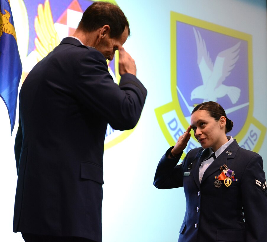 Air Force Airman 1st Class Marie Ann Raguso, 105th Security Forces Squadron, New York Air National Guard, receives the Purple Heart Medal and the Air Force Combat Action Medal from Lt. Gen. Stanley E. Clark III, the director of the Air National Guard, at an awards ceremony at Stewart Air National Guard Base, N.Y., March 2, 2014. A total of 29 medals were awarded to include 5 Bronze Stars, 12 Purple Hearts, and 12 Air Force Combat Action Ribbons to 20 Air Guardsmen of the 105th Base Defense Squadron deployed with the 820th Base Defense Group, Moody Air Force Base, Ga., to provide “outside the wire” base defense of Bagram Airfield, Parwan province, Afghanistan. (U.S. Air National Guard photo by Tech. Sgt. Michael OHalloran/Released)