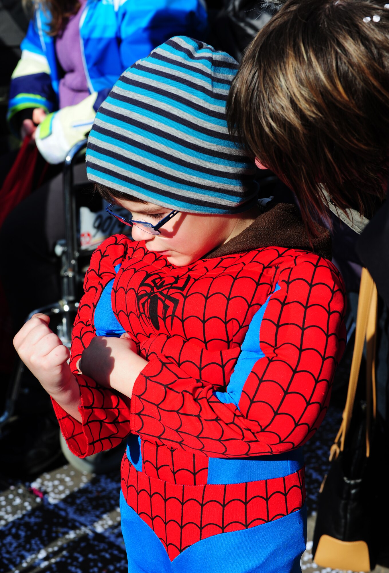 Spiderman flexes his muscles for his mom during the Fasching parade March 4, 2014, Ramstein Village, Germany. This annual event is a pre-Lenten carnival, which is celebrated with the donning of wild and fancy costumes to chase away the evil spirits of winter in preparation for spring. (U.S. Air Force photo/Senior Airman Hailey Haux)