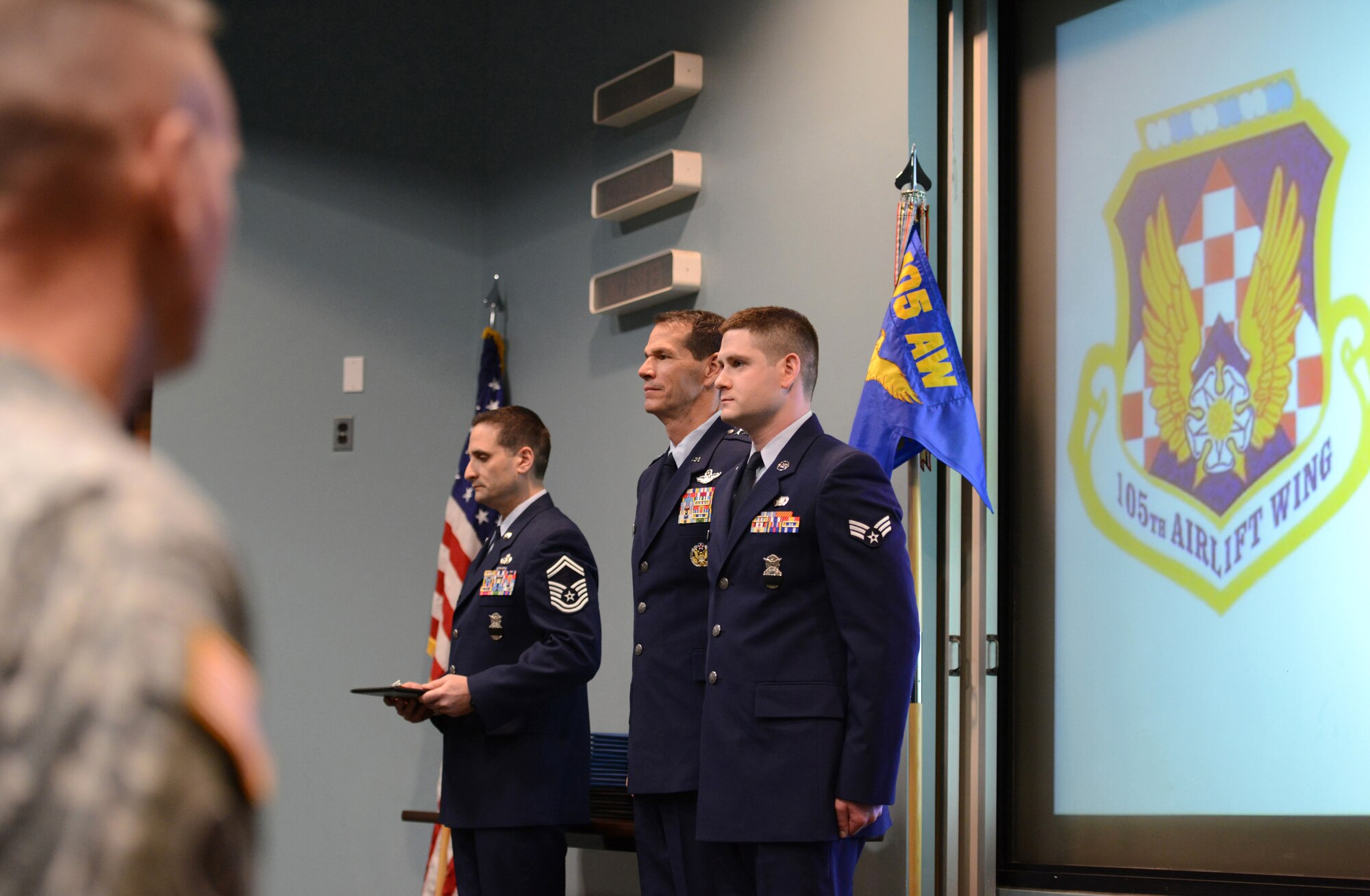 Air Force Senior Airman Justin Murphy, with the 105th Base Defense Squadron, New York Air National Guard, receives the Air Force Combat Action Medal from Lt. Gen. Stanley E. Clark III, the director of the Air National Guard at an awards ceremony at Stewart Air National Guard Base, N.Y., March 2, 2014. A total of 29 medals were awarded to include 5 Bronze Stars, 12 Purple Hearts, and 12 Air Force Combat Action Ribbons to 20 Air Guardsmen of the 105th Base Defense Squadron deployed with the 820th Base Defense Group, Moody Air Force Base, Ga., to provide “outside the wire” base defense of Bagram Airfield, Parwan province, Afghanistan. (U.S. Air National Guard photo by Tech. Sgt. Michael OHalloran/Released)