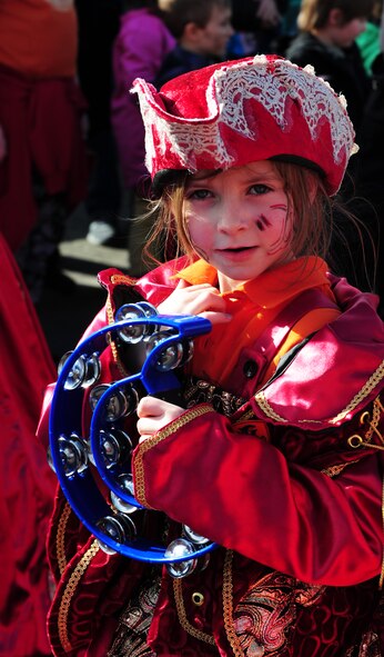 A girl plays the tambourine during the annual Fasching parade March 4, 2014, Ramstein Village, Germany. This annual event is a pre-Lenten carnival, which is celebrated with the donning of wild and fancy costumes to chase away the evil spirits of winter in preparation for spring. (U.S. Air Force photo/Senior Airman Hailey Haux)