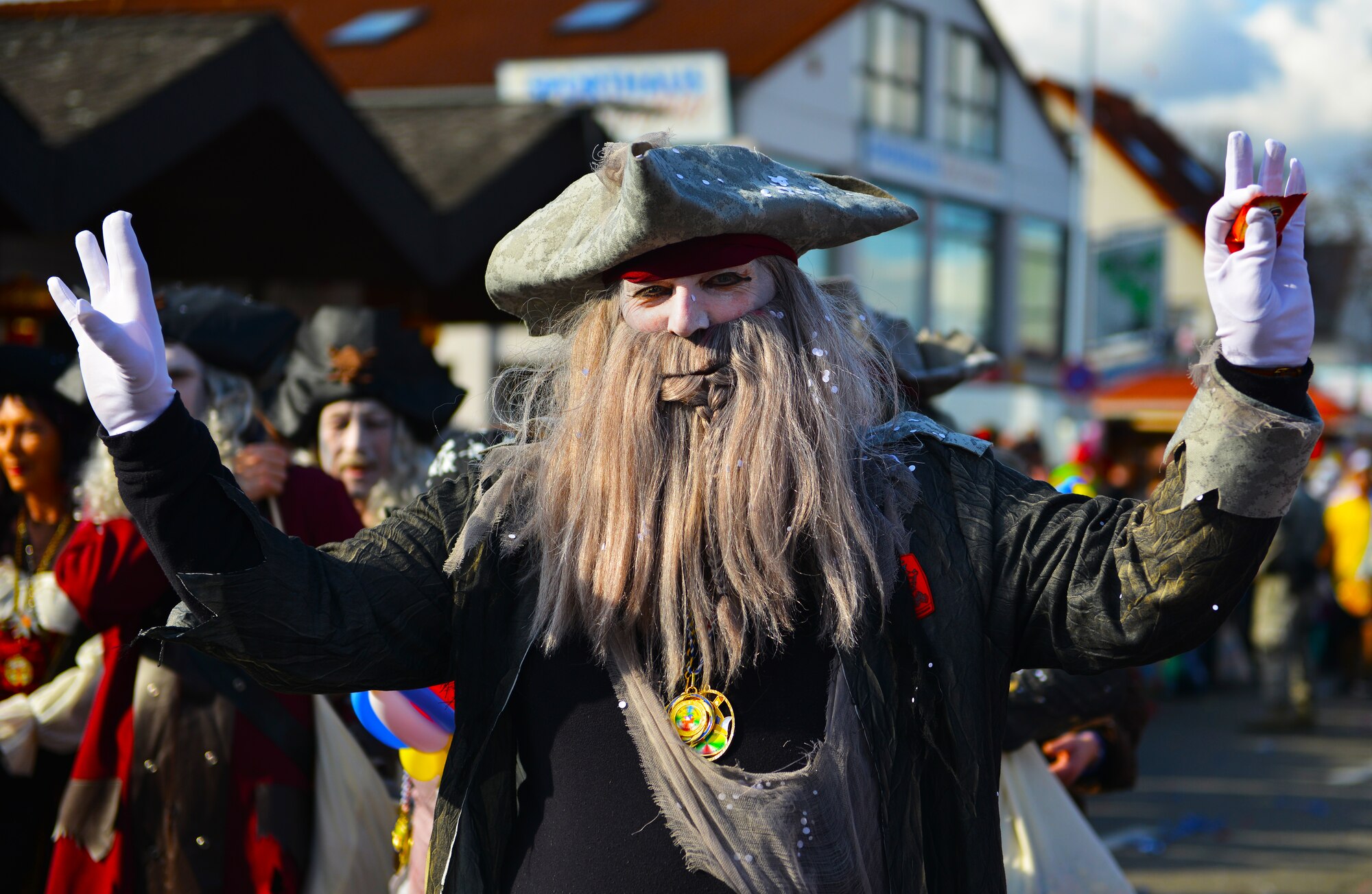 A member of the Fasching parade waves to the crowd March 4, 2014, Ramstein Village, Germany. This annual event is a pre-Lenten carnival, which is celebrated with the donning of wild and fancy costumes to chase away the evil spirits of winter in preparation for spring. (U.S. Air Force photo/Airman Dymekre Allen)