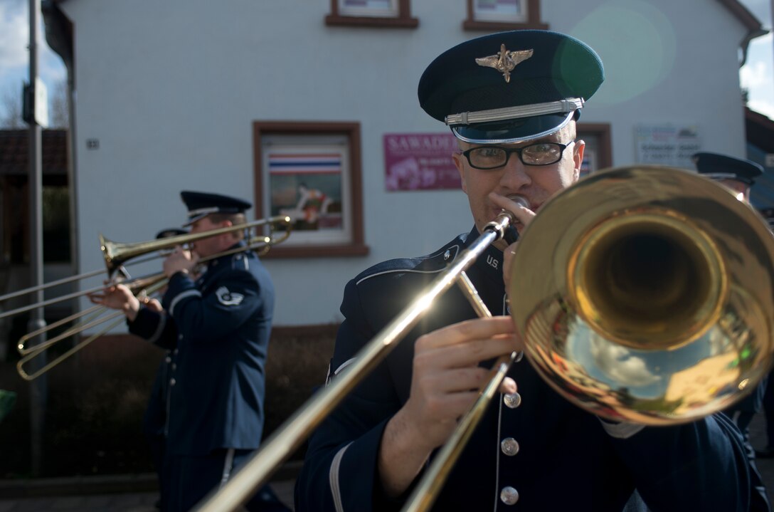 Senior Airman Ben Huseby, USAFE band member, plays a trombone during an annual Fasching parade, March 4, 2014, Ramstein Village, Germany. This annual event is a pre-Lenten carnival, which is celebrated with the donning of wild and fancy costumes to chase away the evil spirits of winter in preparation for spring. (U.S. Air Force photo/Airman 1st Class Jordan Castelan)