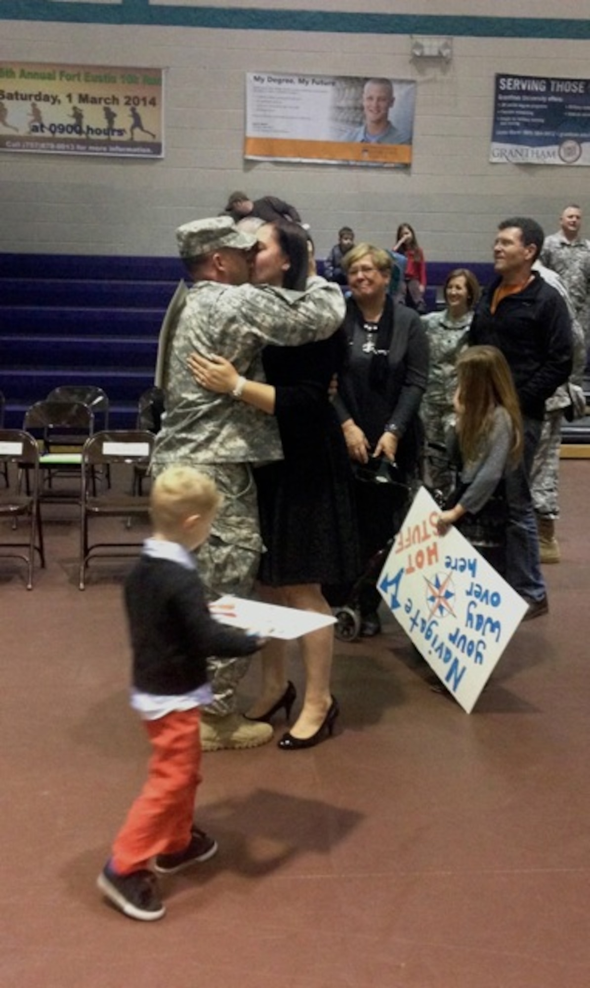 A Soldier from 1099th Transportation Company (medium boat), 10th Transportation Battalion, 7th Transportation Brigade (Expeditionary) greets his family during a redeployment ceremony at Fort Eustis, Va., Feb. 24, 2014.  The 1099th Trans. Co. returned from a nine-month deployment in Kuwait. (U.S. Army photo by Sgt. Stefanie Warner/Released)