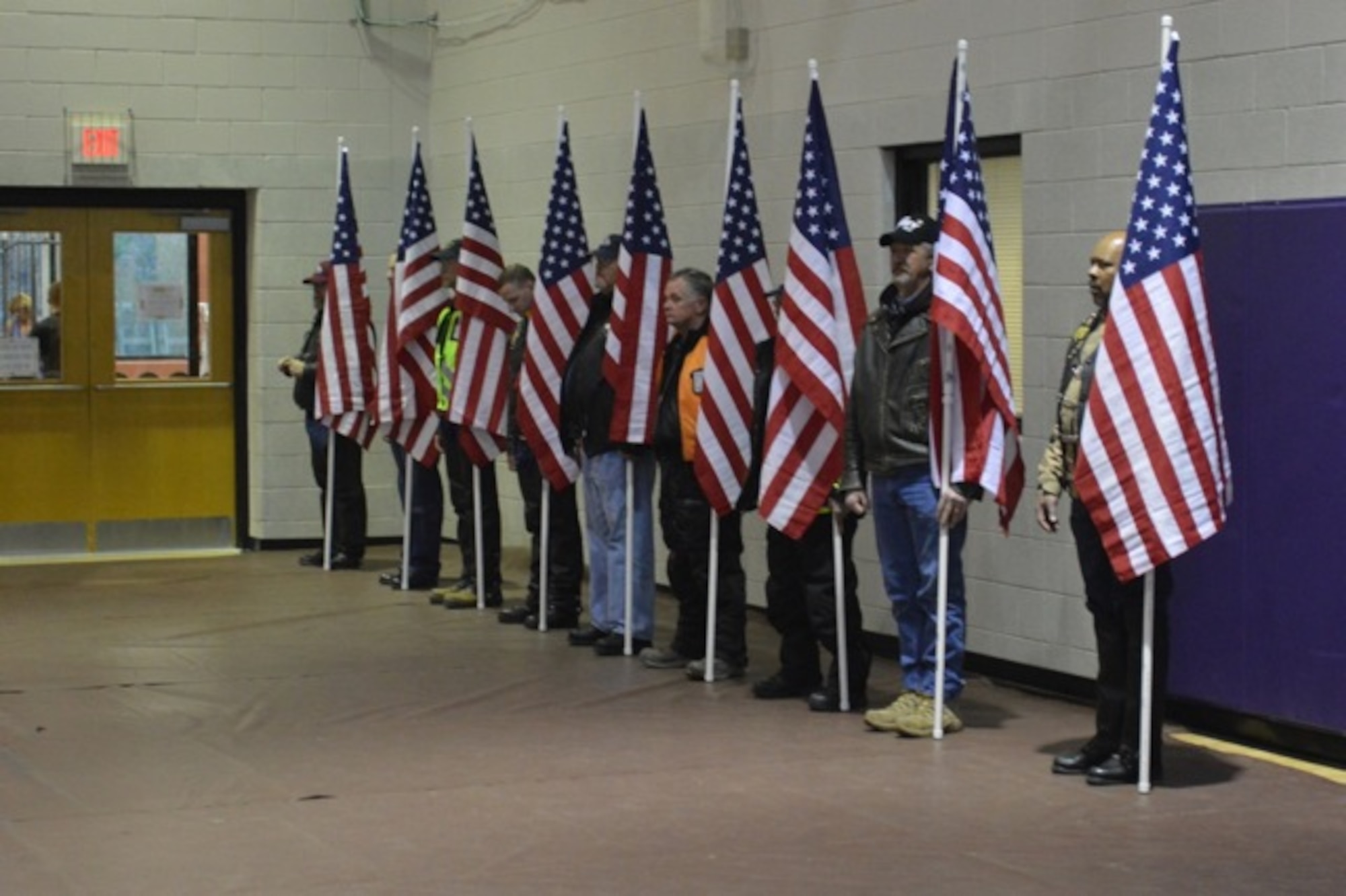 Local Freedom Riders hold flags during the welcome home ceremony for the 1099th Transportation Company (medium boat), 10th Transportation Battalion, 7th Transportation Brigade (Expeditionary), at Fort Eustis, Va., Feb. 24, 2014. The Freedom Riders is a veterans riding club, and the group escorted the Soldiers’ bus to the ceremony.  (U.S. Army photo by Sgt. Stefanie Warner/Released)