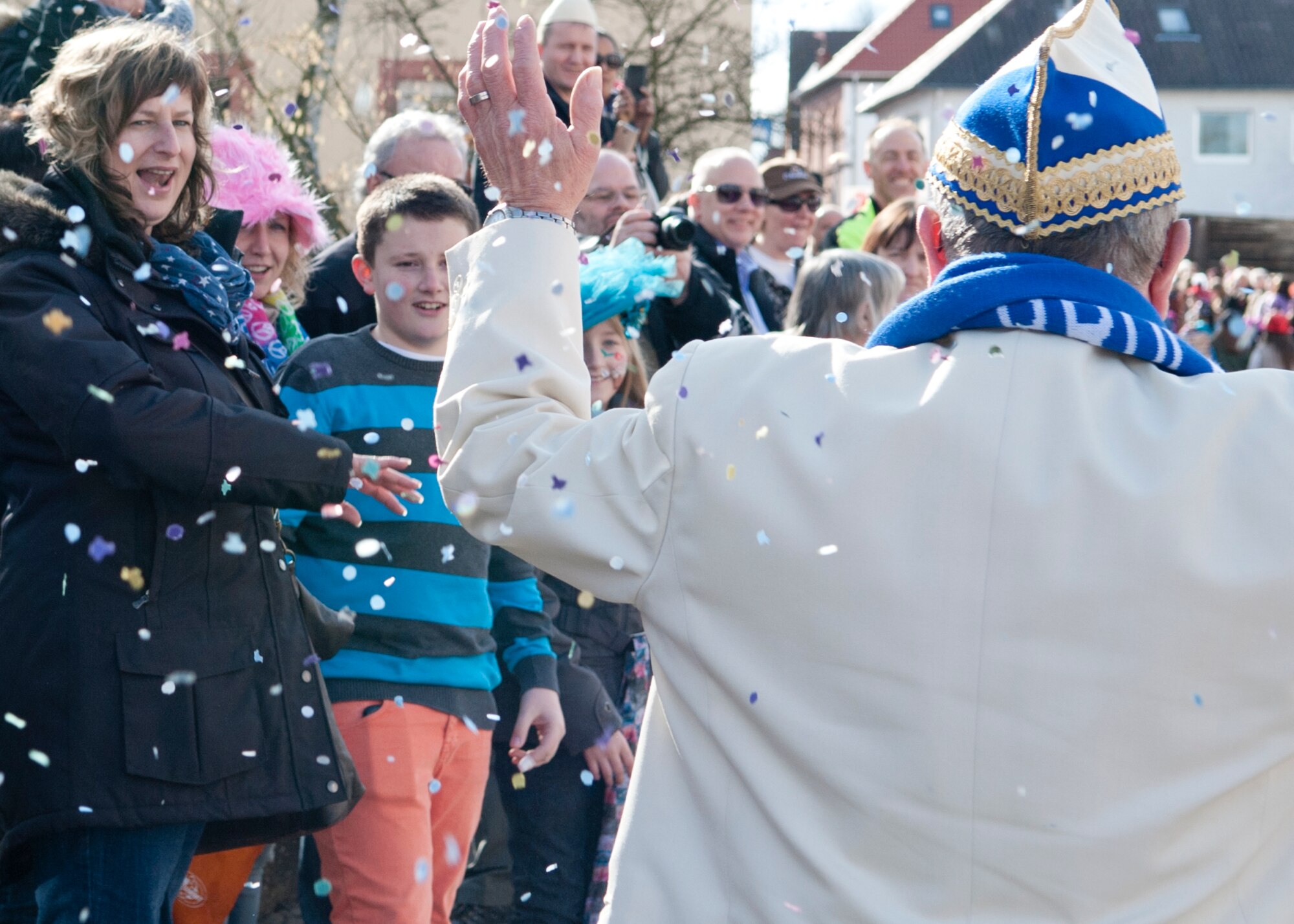 Fasching parade attendees cheer as parade participants pass by March 4, 2014, Ramstein Village, Germany. This annual event is a pre-Lenten carnival, which is celebrated with the donning of wild and fancy costumes to chase away the evil spirits of winter in preparation for spring.  (U.S. Air Force photo/Airman Larissa Greatwood)