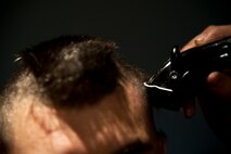 Air crew members from the 23rd Bomb Squadron shave the hair off their heads at Minot Air Force Base, N.D., Feb. 21, 2014. The crew members shaved their heads to support Brayden Mitchell, who has diagnosed with a stage three Wilms tumor, a form of kidney cancer. Capt. Michael DeVita, 23rd BS B-52 instructor pilot, is a friend of the Mitchell family. (U.S. Air Force photo/Senior Airman Brittany Y. Auld)