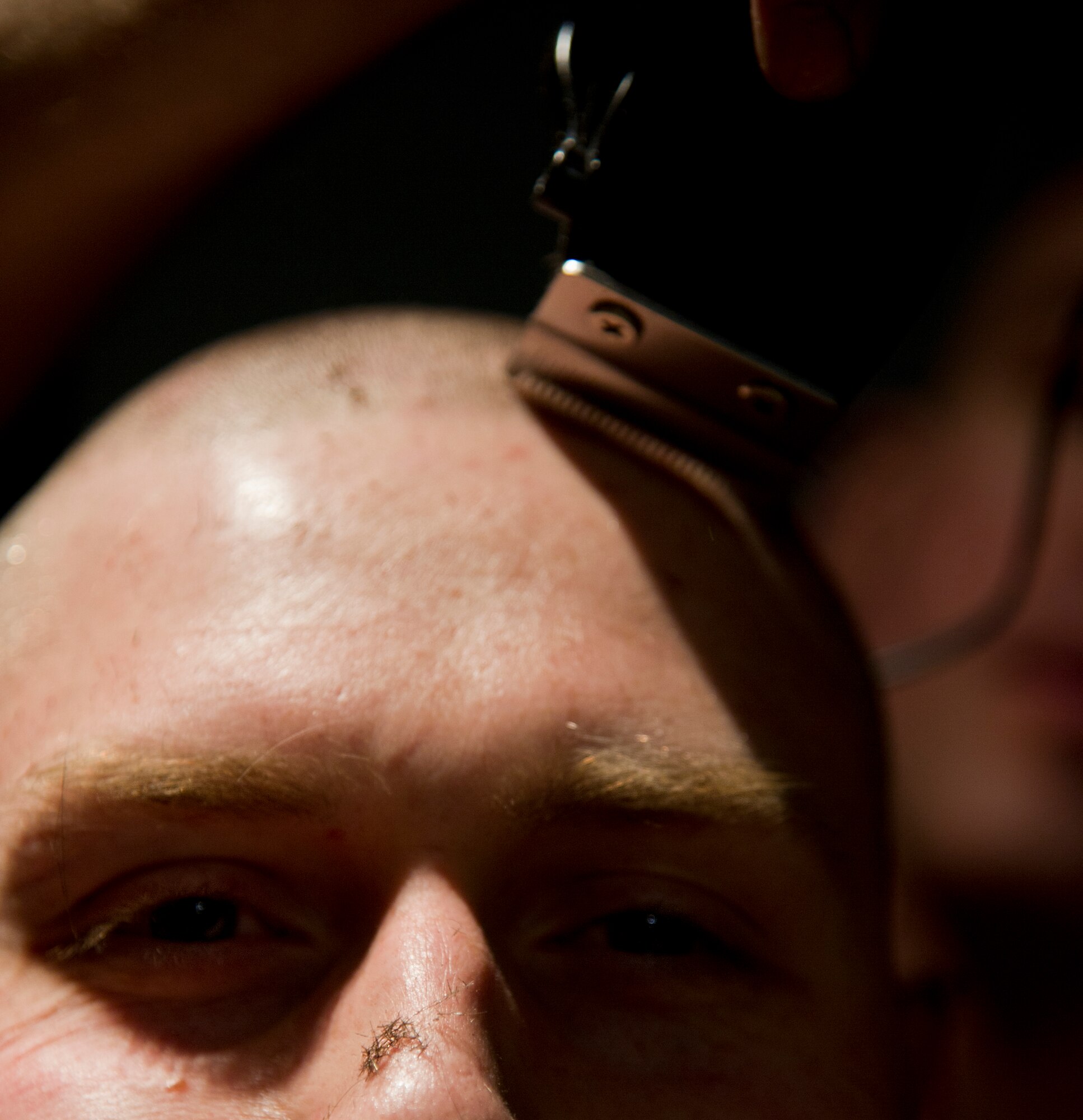 Air crew members from the 23rd Bomb Squadron shave the hair off their heads at Minot Air Force Base, N.D., Feb. 21, 2014. The crew members shaved their heads to support Brayden Mitchell, who has diagnosed with a stage three Wilms tumor, a form of kidney cancer. Capt. Michael DeVita, 23rd BS B-52 instructor pilot, is a friend of the Mitchell family. (U.S. Air Force photo/Senior Airman Brittany Y. Auld)