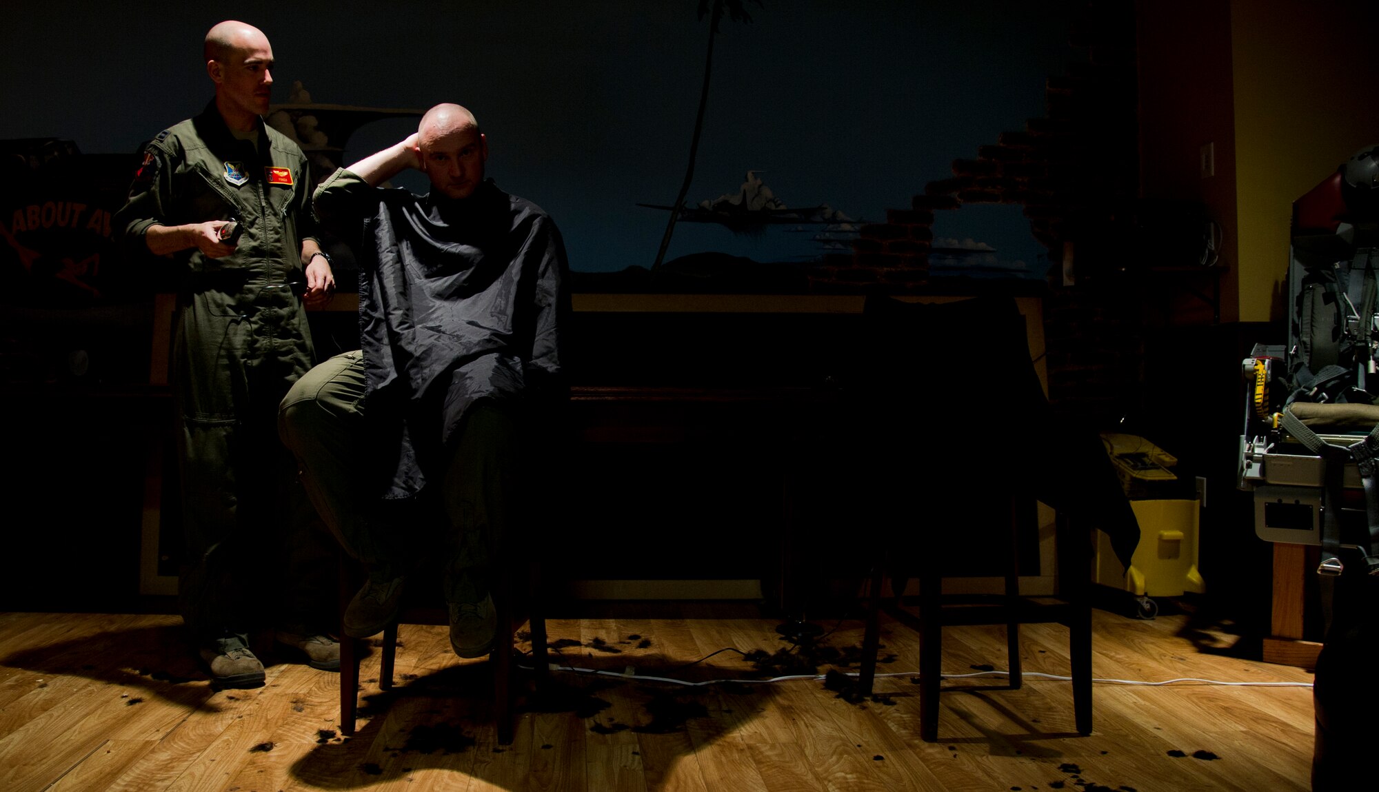 Air crew members from the 23rd Bomb Squadron shave the hair off their heads at Minot Air Force Base, N.D., Feb. 21, 2014. The crew members shaved their heads to support Brayden Mitchell, who has diagnosed with a stage three Wilms tumor, a form of kidney cancer. Capt. Michael DeVita, 23rd BS B-52 instructor pilot, is a friend of the Mitchell family. (U.S. Air Force photo/Senior Airman Brittany Y. Auld)