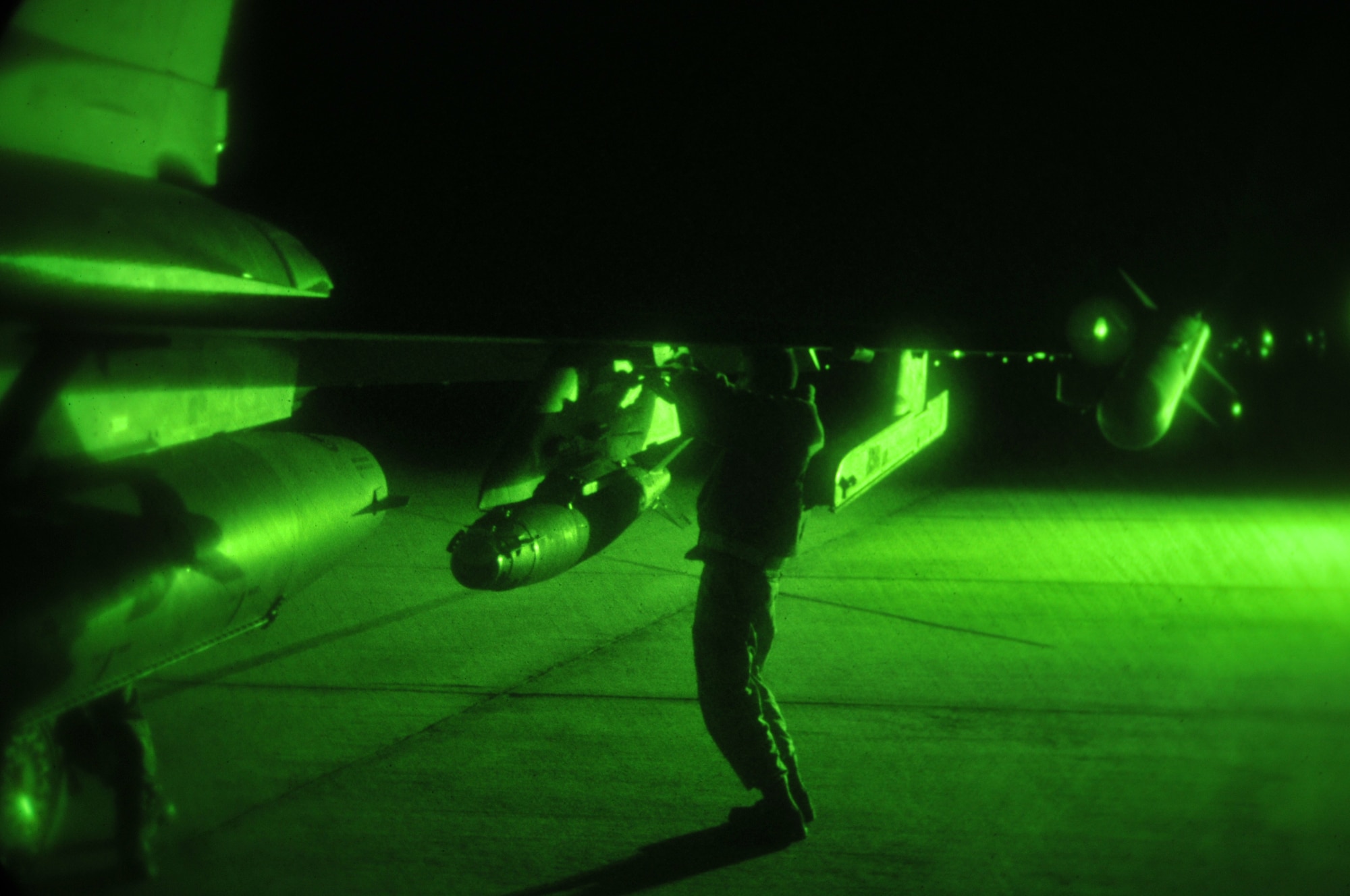 Alabama Air National Guard Airman 1st Class Dustin Cornelius inspects a weapons pylon on an F-16 Fighting Falcon at Dannelly Field Air National Guard Base, Ala., Feb. 26, 2014. Night flying operations are used to train pilots and ground crews on how to operate fly and fight at night. (U.S. Air Force photo by Tech. Sgt. Matthew Garrett)