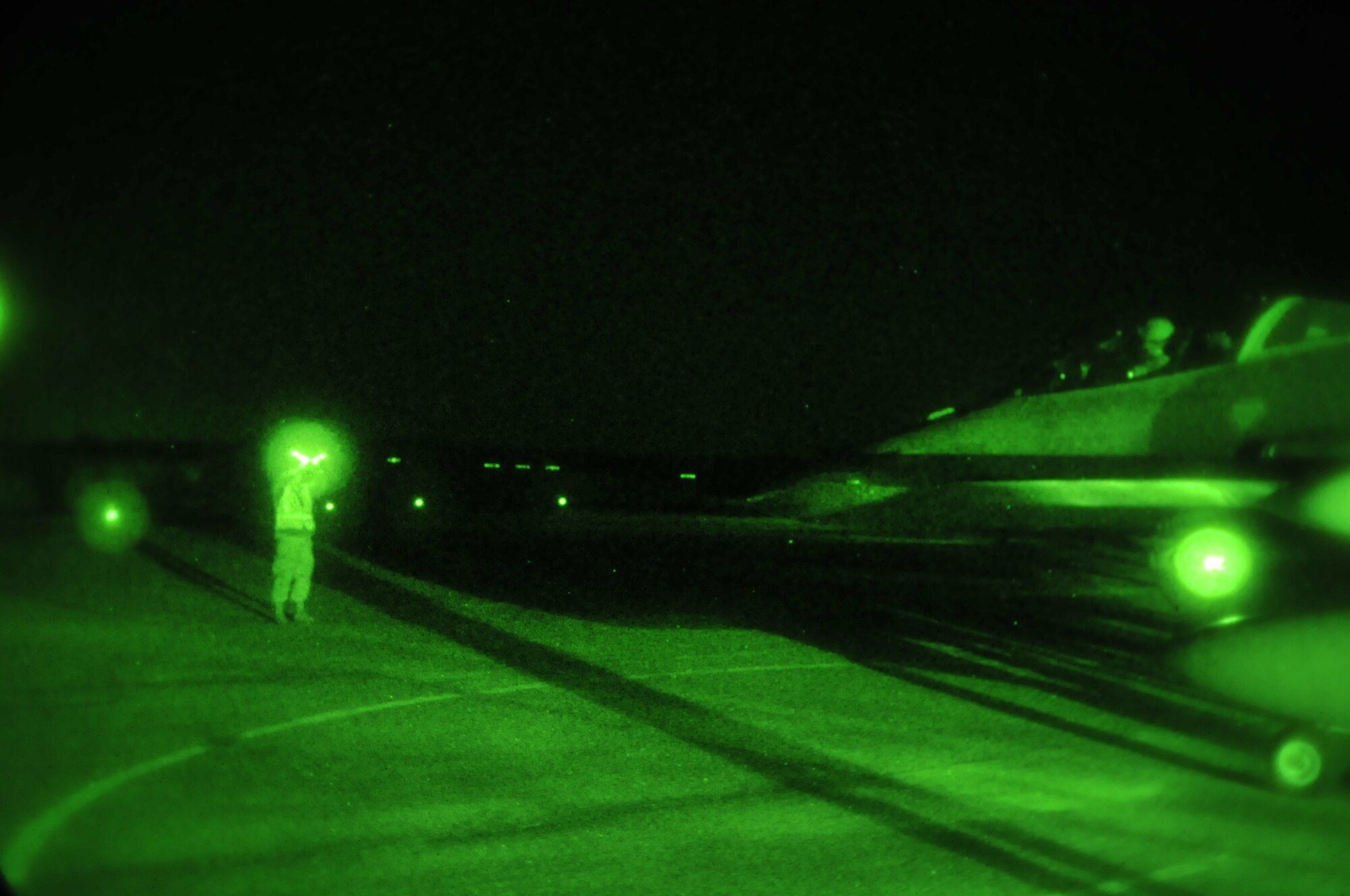 Alabama Air National Guard Staff Sgt. Brandon Blackburn marshals an F-16 Fighting Falcon to the End of Runway (EOR) during night flying operations at Dannelly Field Air National Guard Base, Ala., Feb. 26, 2014. The EOR is used for final system checks of the F-16 before the aircraft takes off. (U.S. Air Force photo by Tech. Sgt. Matthew Garrett)