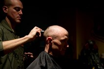Air crew members from the 23rd Bomb Squadron shave their heads to support Brayden Mitchell, who has diagnosed with a stage three Wilms tumor, a form of kidney cancer. Capt. Michael DeVita, 23rd BS B-52 instructor pilot, is a friend of the Mitchell family. (U.S. Air Force photo/Senior Airman Brittany Y. Auld)