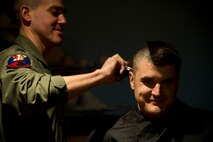 Air crew members from the 23rd Bomb Squadron shave the hair off their heads at Minot Air Force Base, N.D., Feb. 21, 2014. The crew members shaved their heads to support a 5-year-old cancer patient. (U.S. Air Force photo/Senior Airman Brittany Y. Auld)